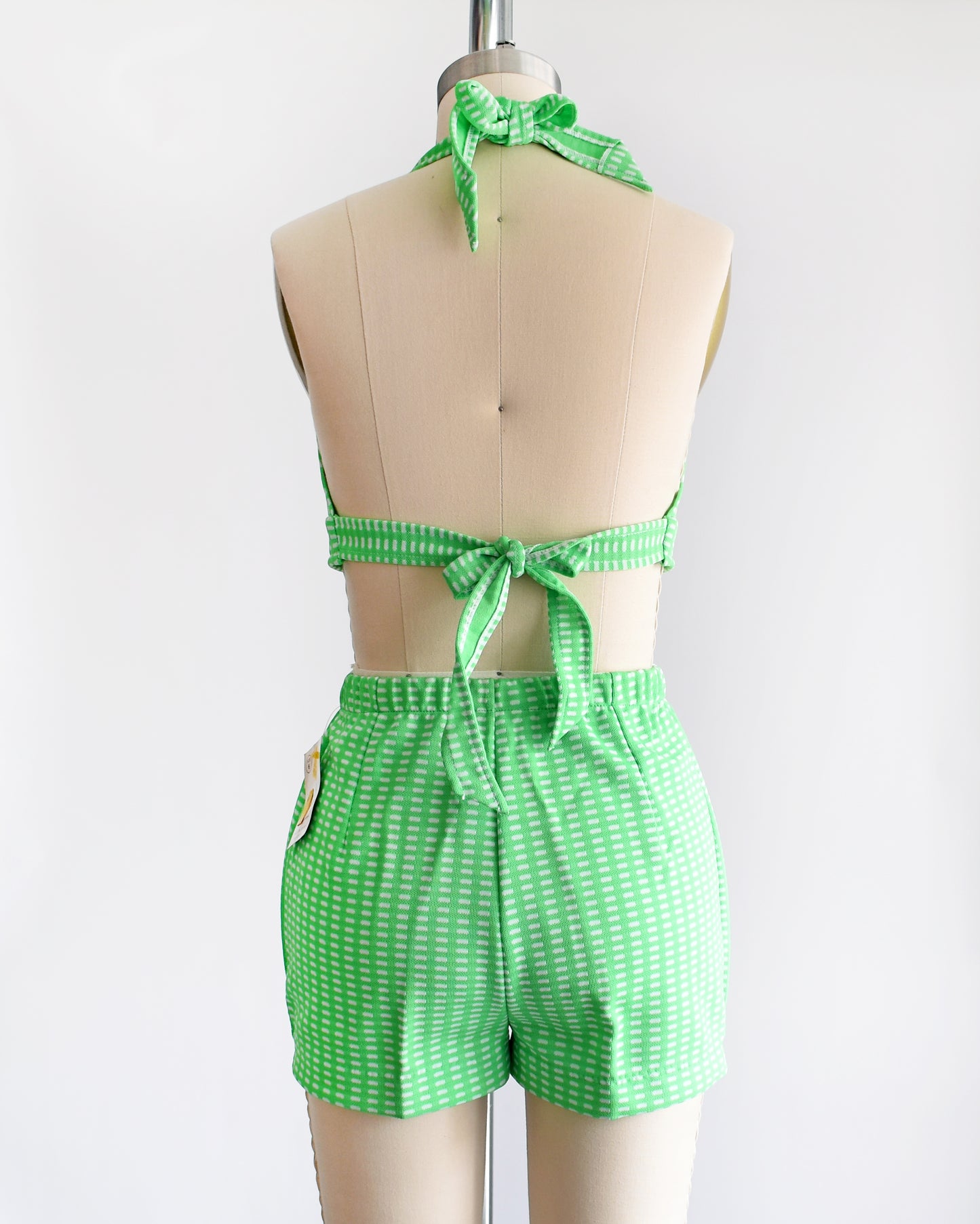 back view of a vintage 1970s green two piece halter top and short set