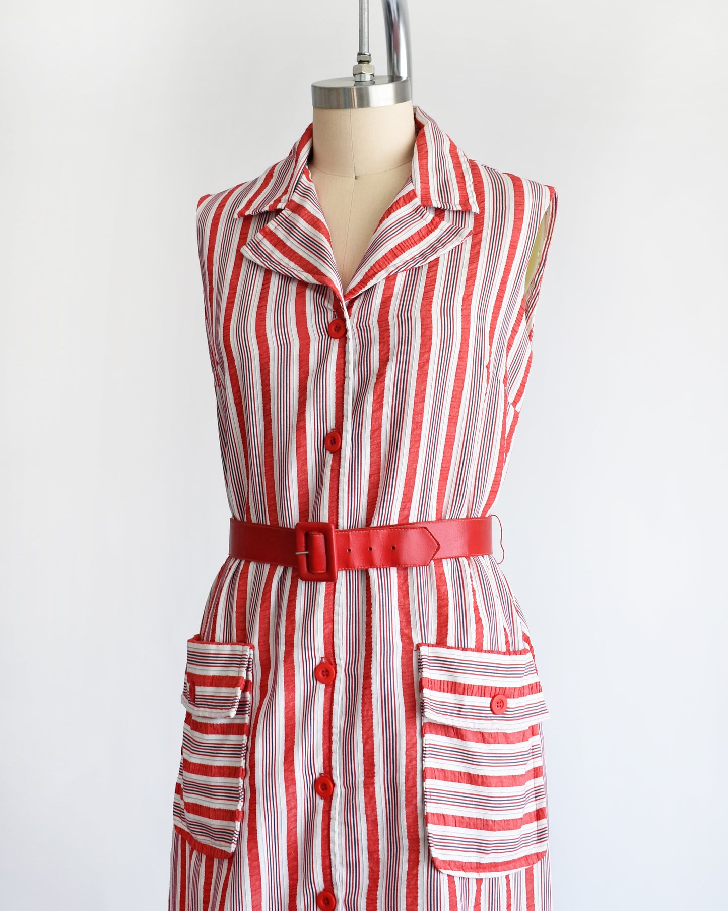 side front view of a vintage 1970s red and white striped dress on a mannequin against a white background
