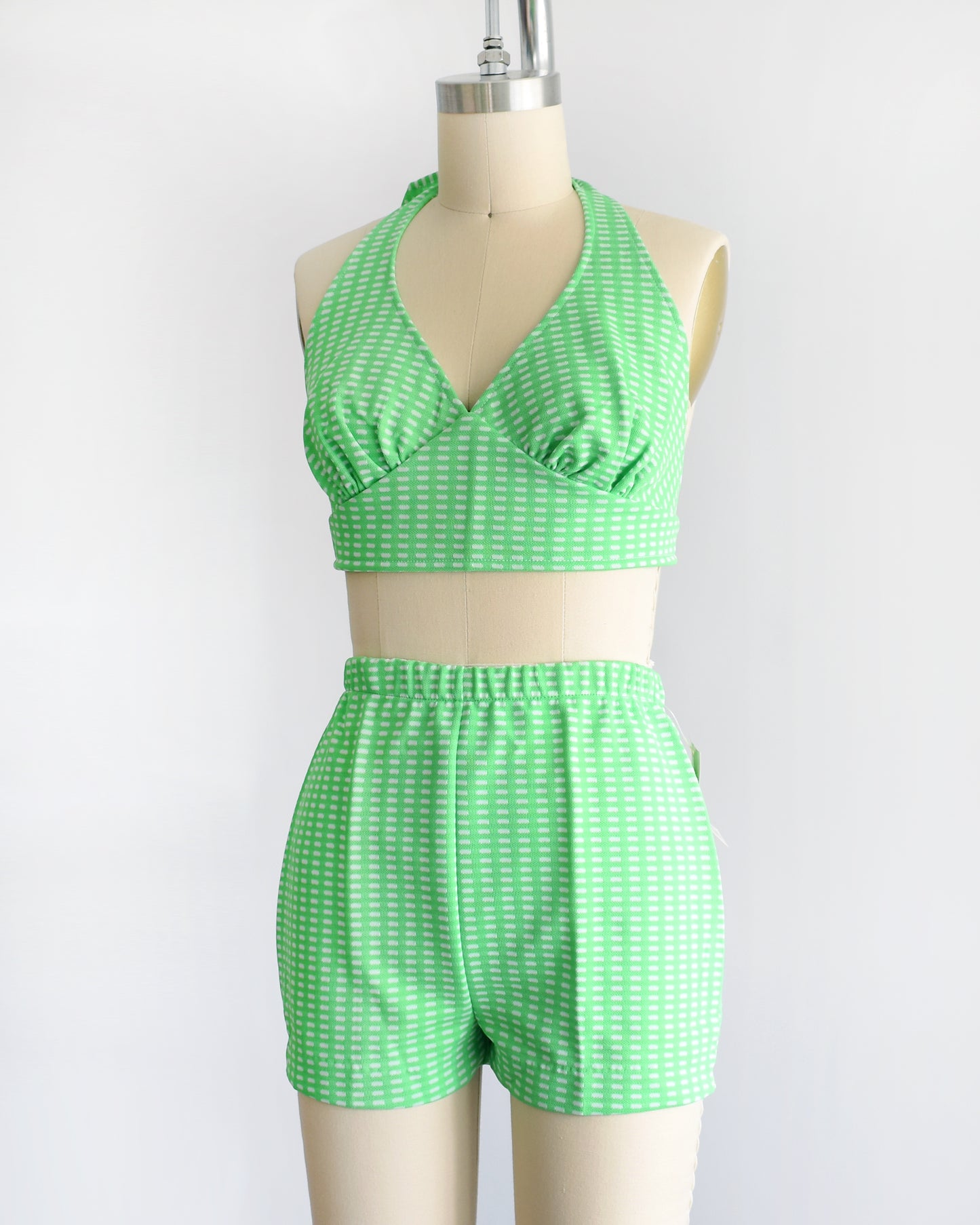 side front view of a vintage 1970s green two piece halter top and short set