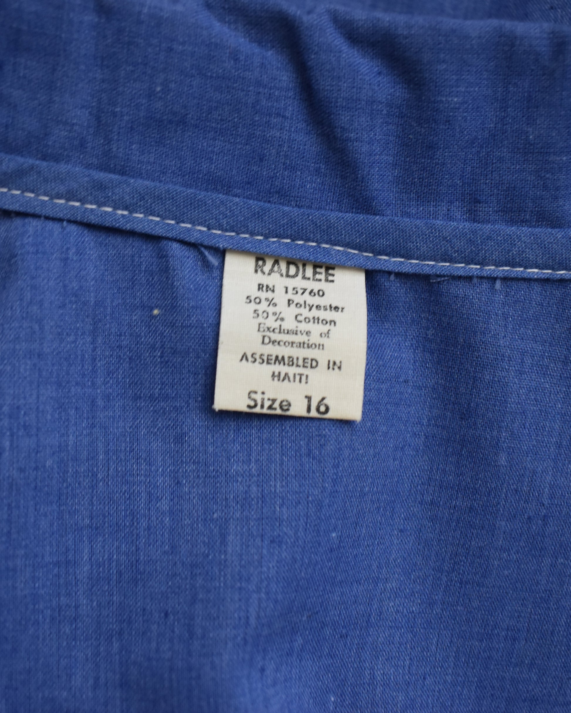 Close-up of a blue fabric with a Radlee label on a blue background