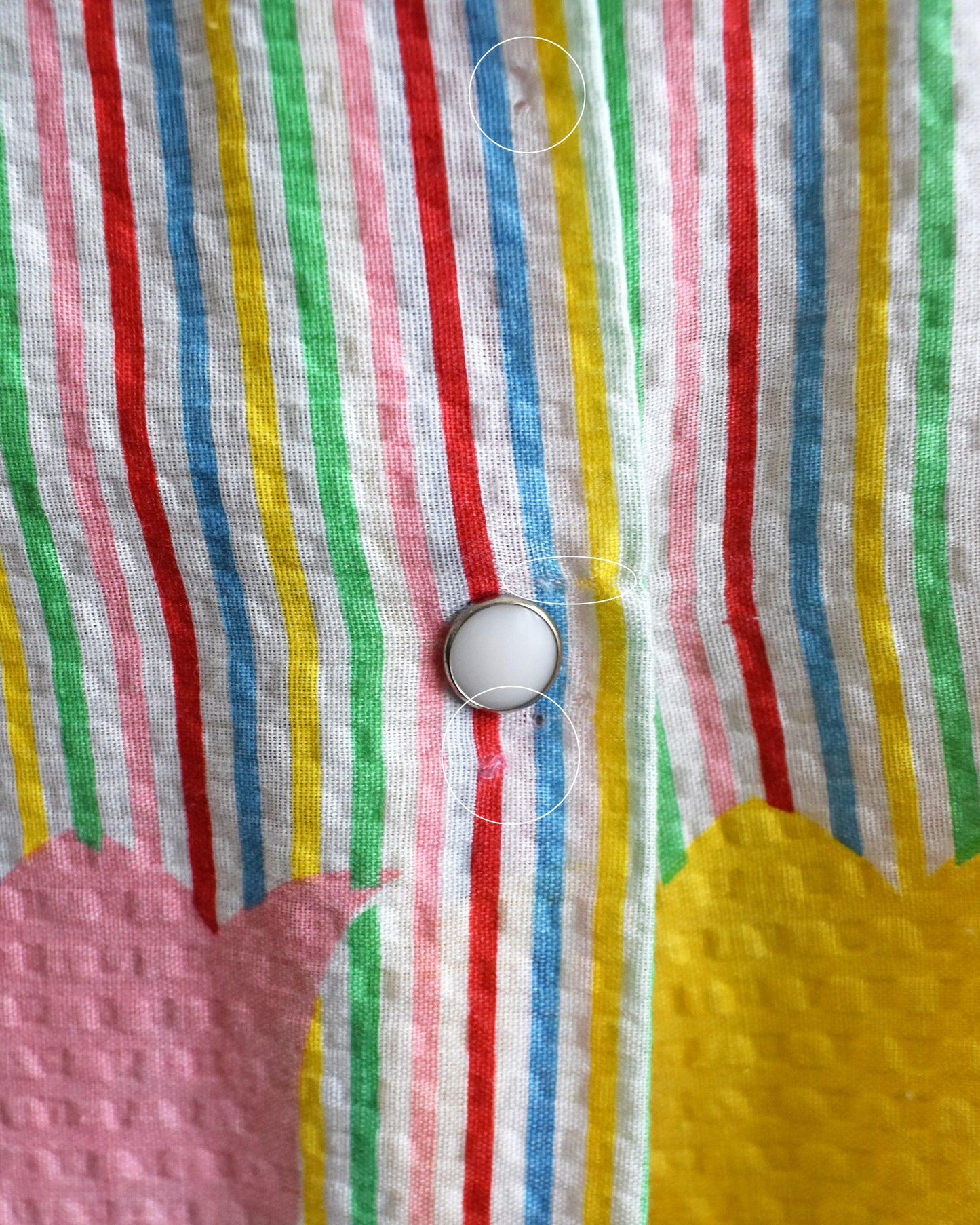 close up of small holes near the last button