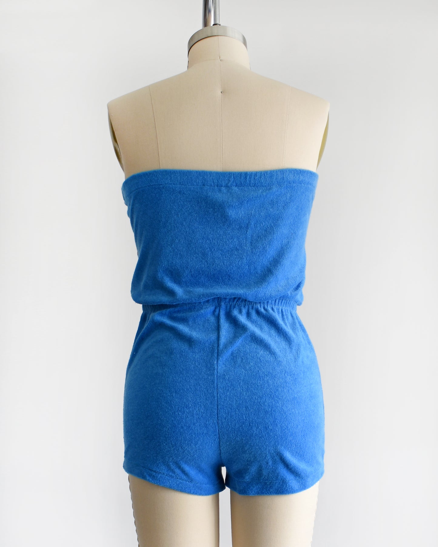 back view of a vintage late 1970s early 1980s blue terry cloth romper 