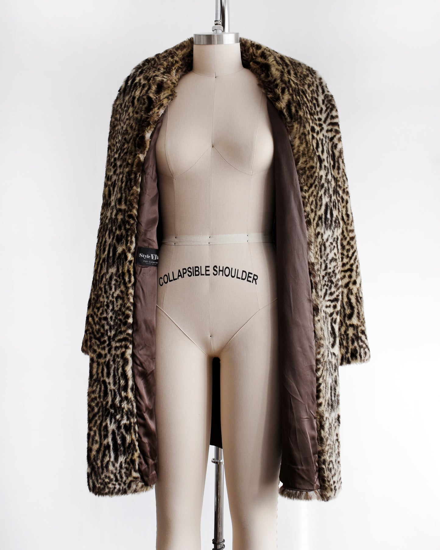 a vintage 1980s faux fur leopard print coat on a mannequin against a white background. the coat is open in this photo