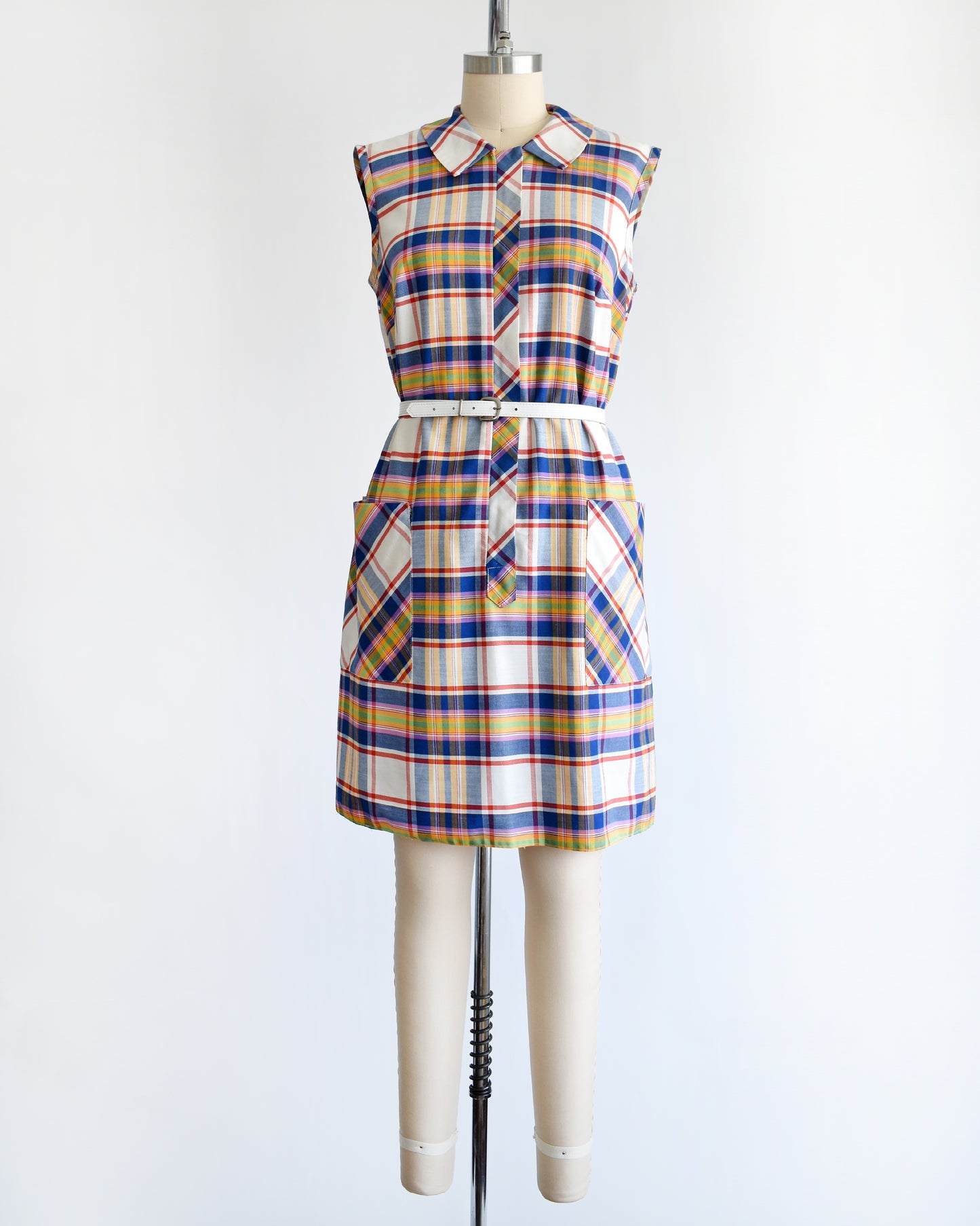 a vintage 1960s/1970s plaid dress on a mannequin against a white background
