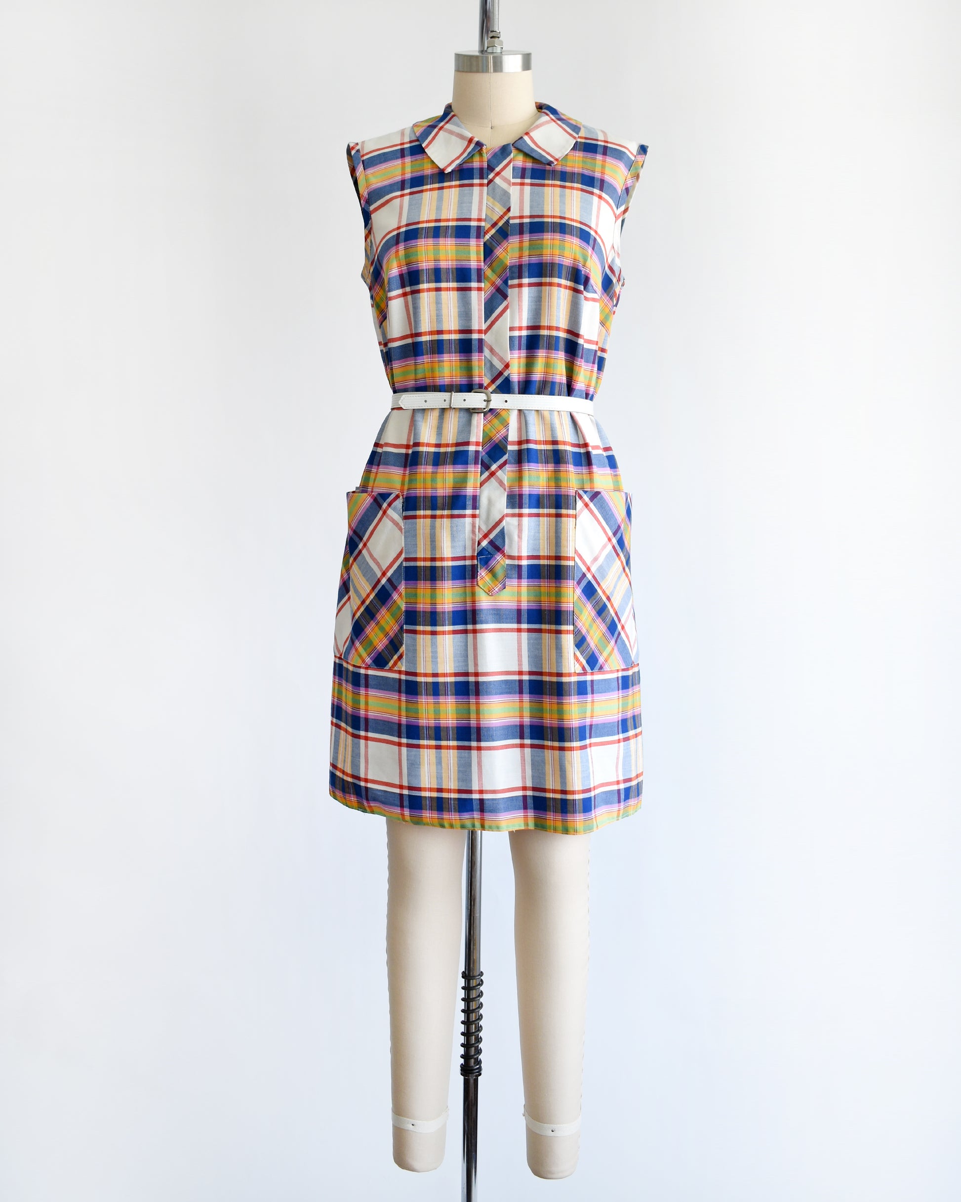 a vintage 1960s/1970s plaid dress on a mannequin against a white background