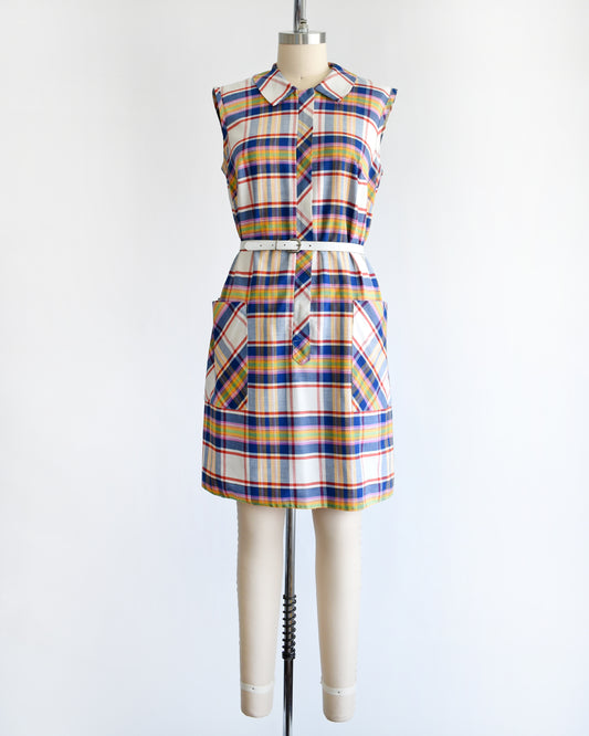 a vintage 1960s/1970s plaid dress on a mannequin against a white background