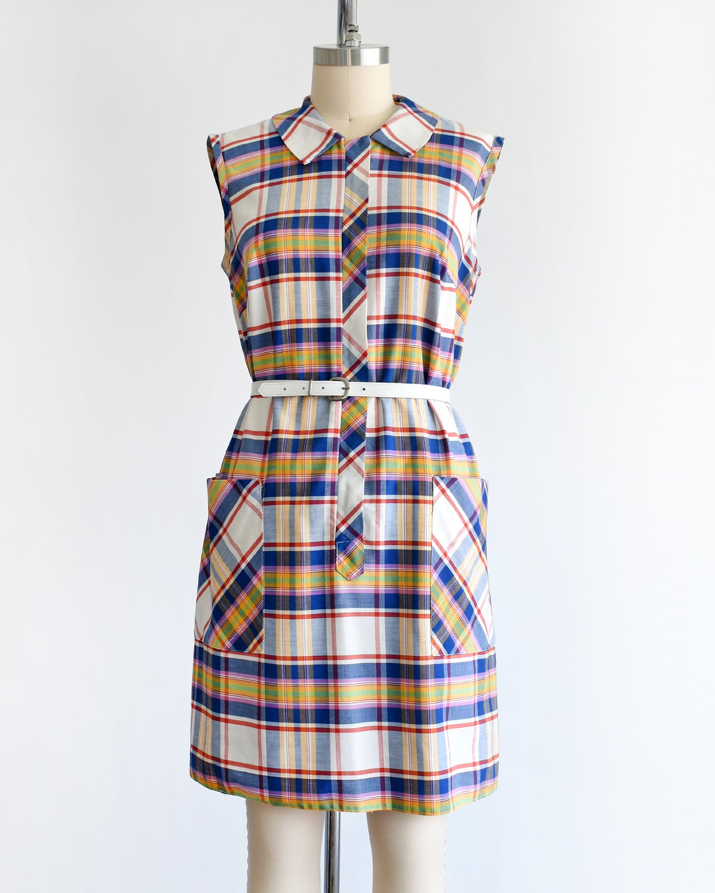 a vintage 1960s/1970s plaid dress on a mannequin against a white background