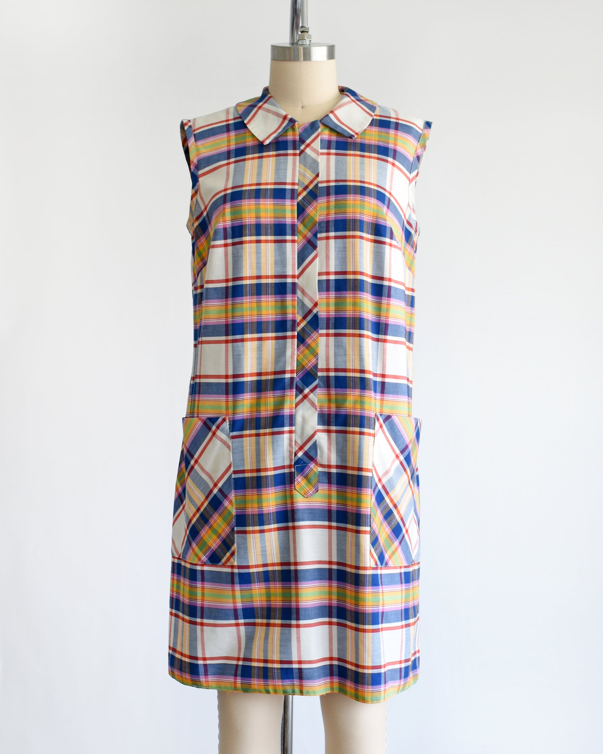 a vintage 1960s/1970s plaid dress on a mannequin against a white background