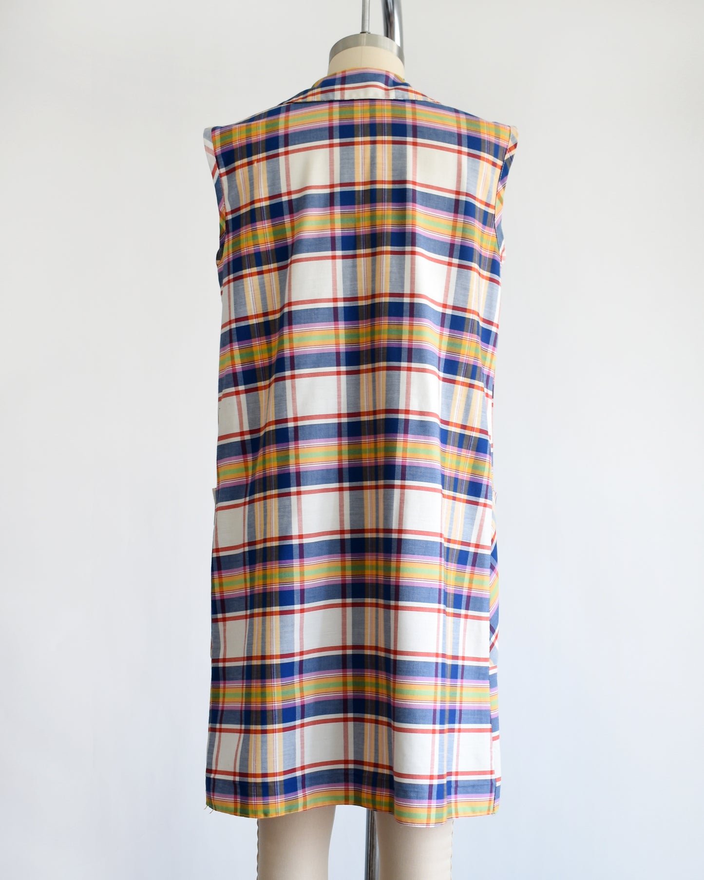 back view of a vintage 1960s/1970s plaid dress on a mannequin against a white background