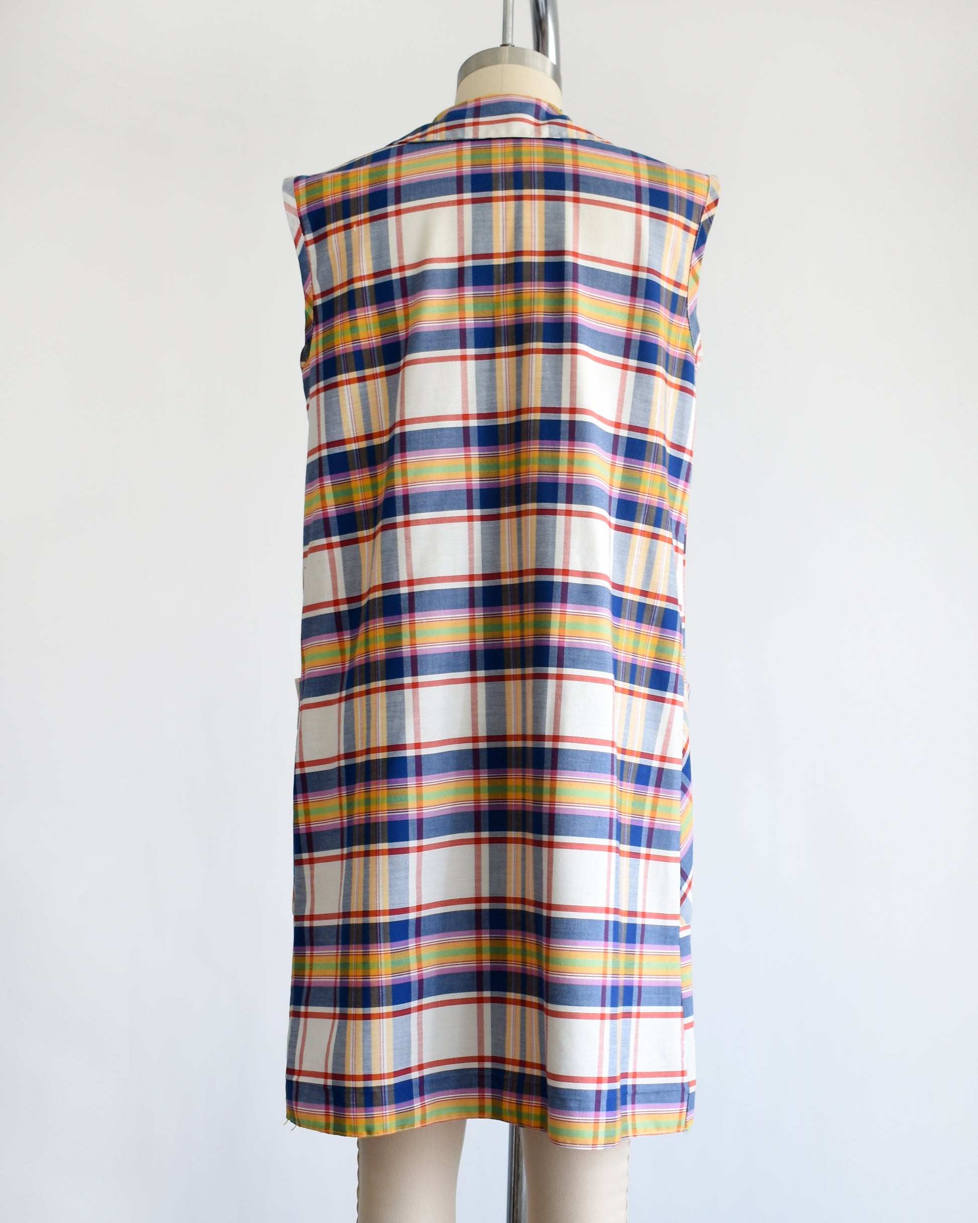 back view of a vintage 1960s/1970s plaid dress on a mannequin against a white background