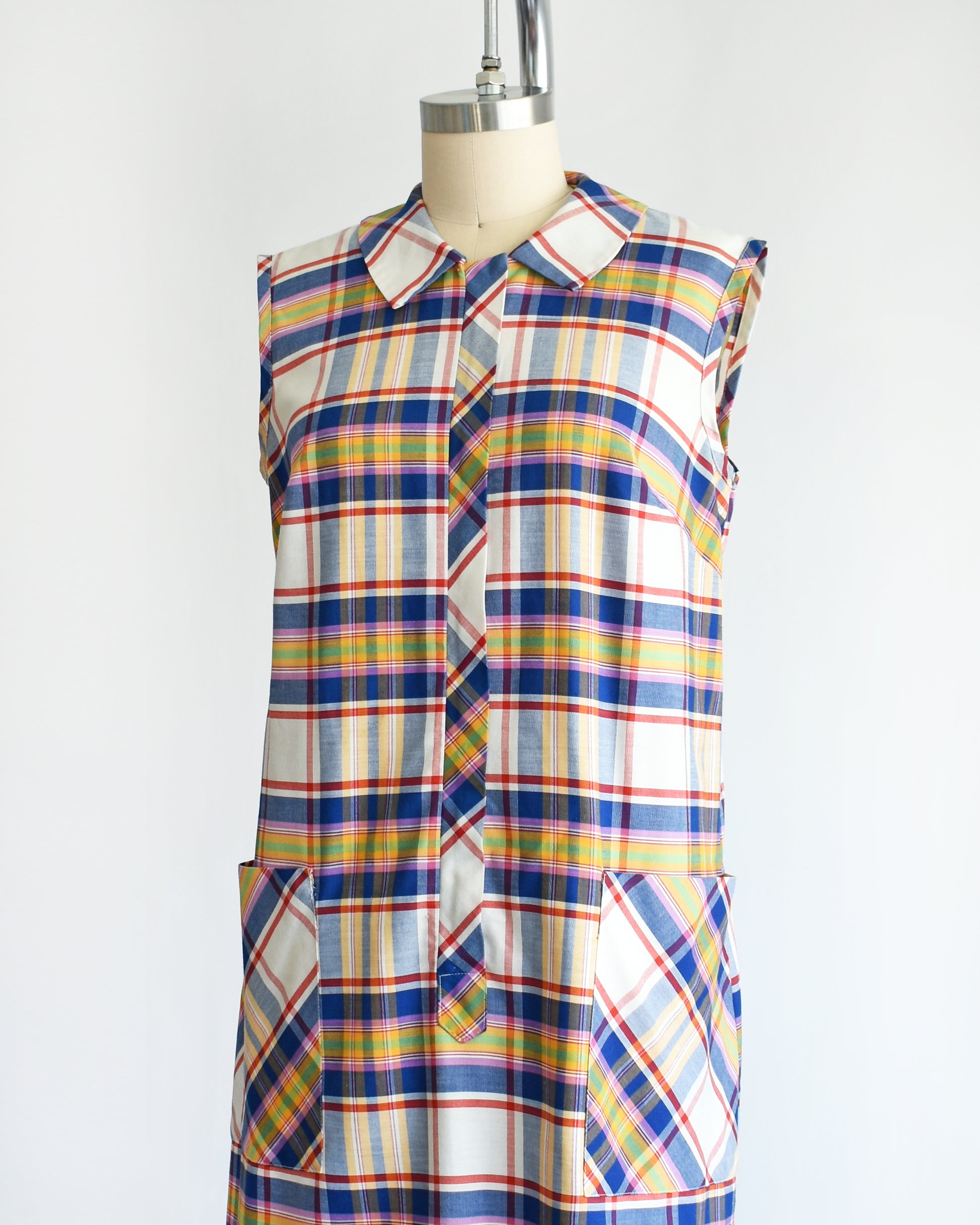 side front view of a vintage 1960s/1970s plaid dress on a mannequin against a white background