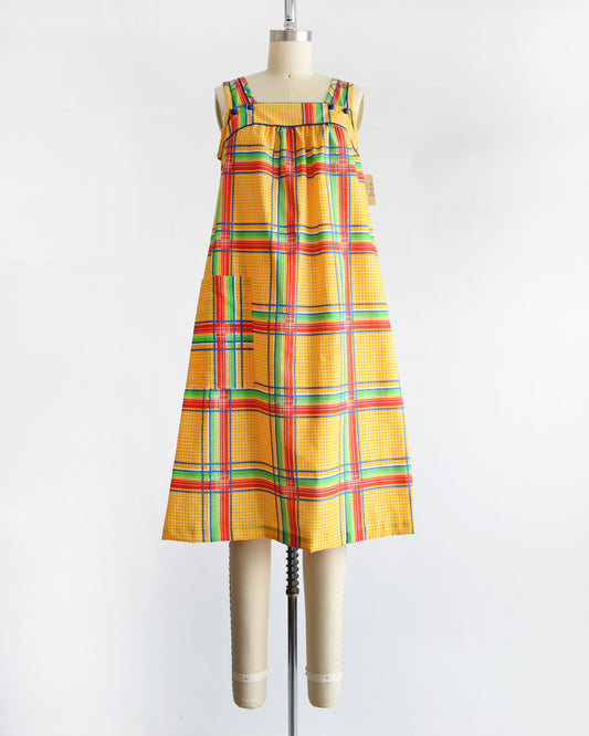 a vintage 1970s yellow plaid dress on a mannequin against a white background