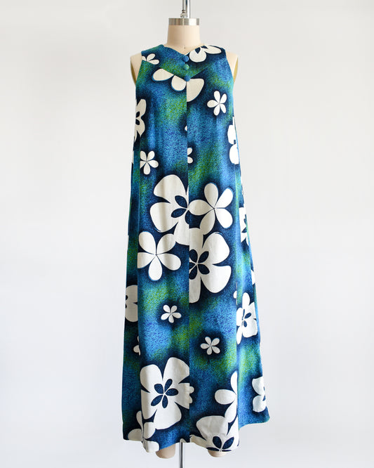 a vintage 1970s blue and green Hawaiian maxi dress with white floral print