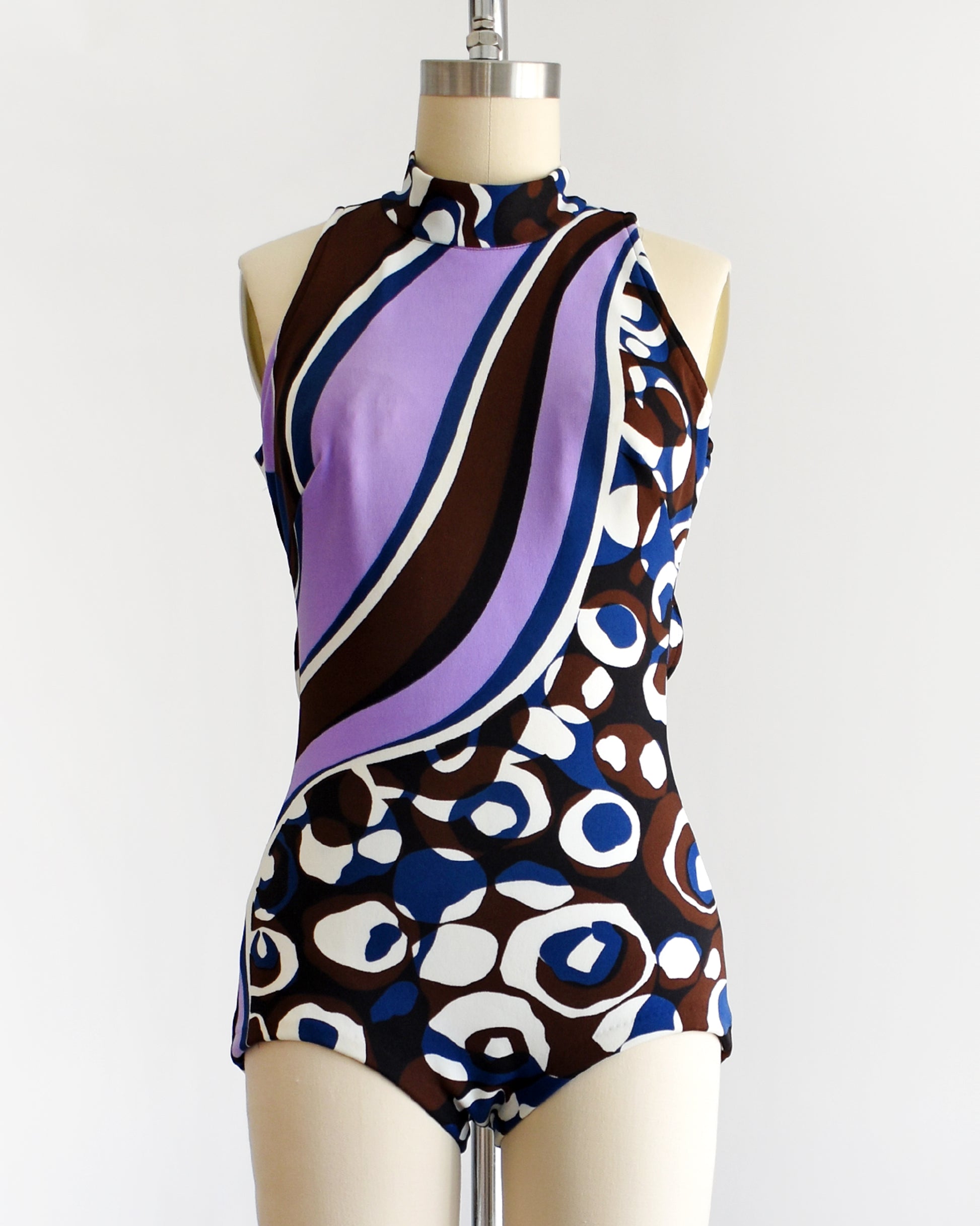 a vintage 1960s psychedelic swimsuit on a mannequin against a white background