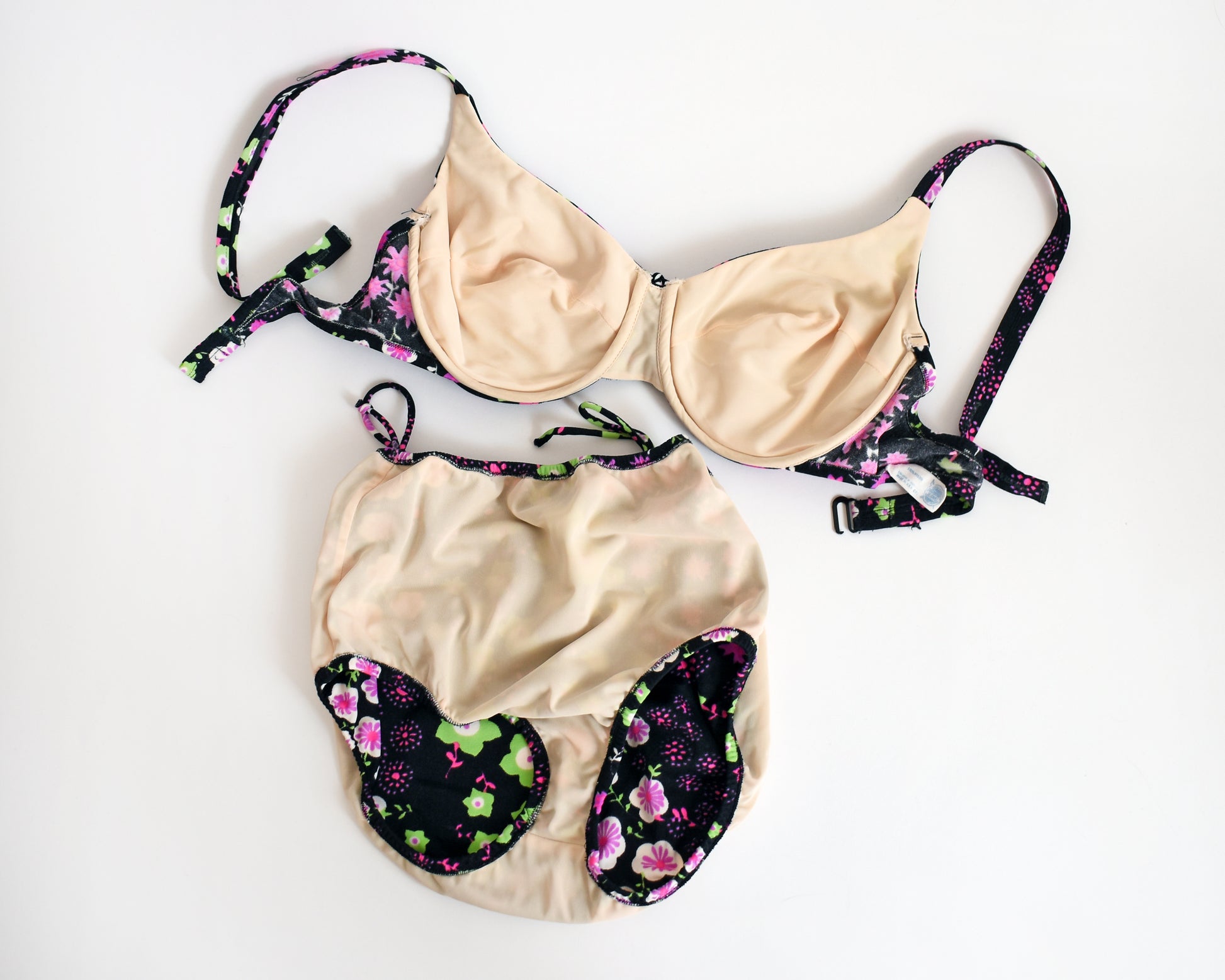 flat lay of the bikini which is turned inside out showing the beige lining