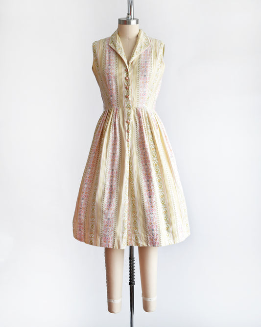 a vintage 1950s dress on a mannequin against a white background