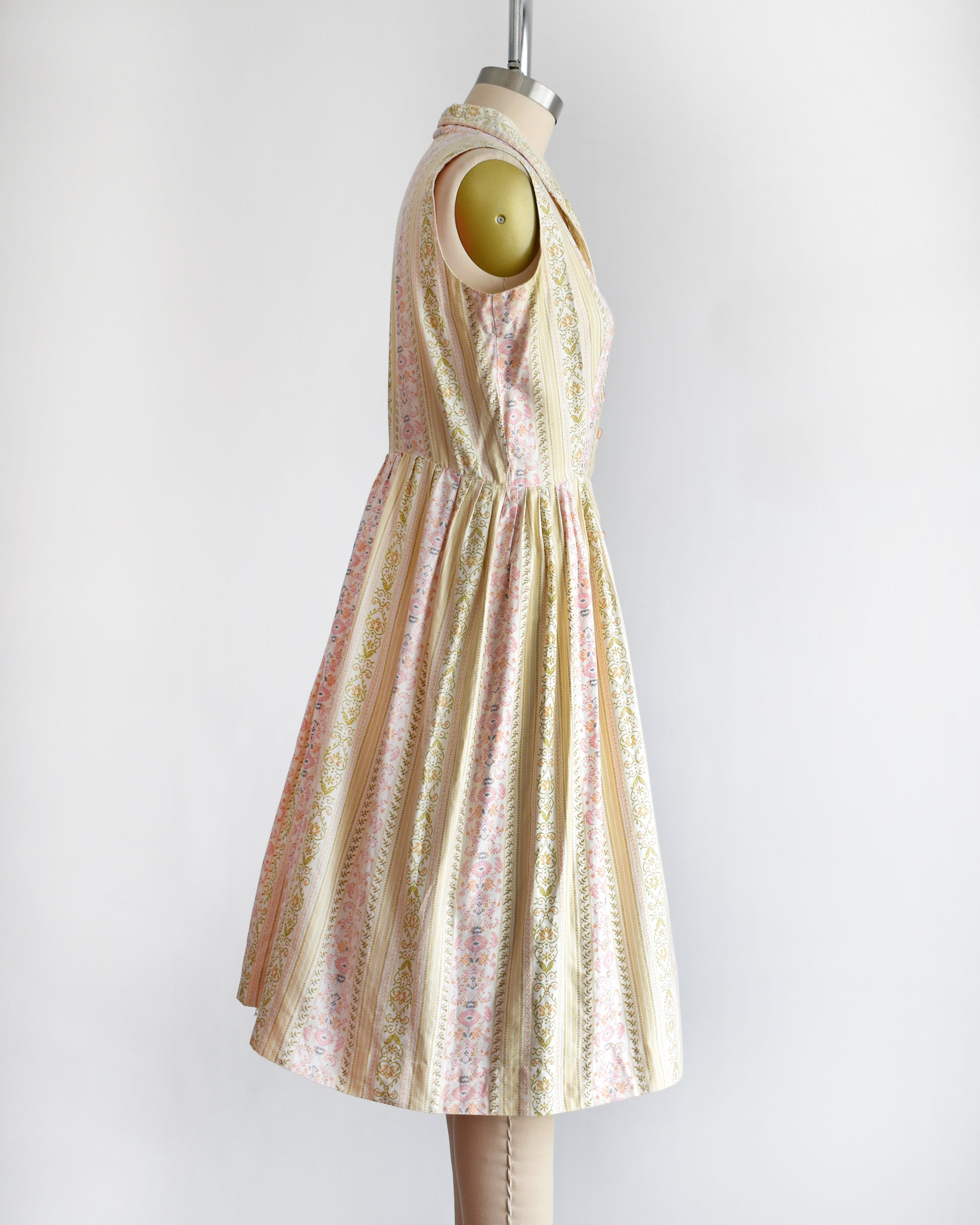 side view of a vintage 1950s dress on a mannequin against a white background
