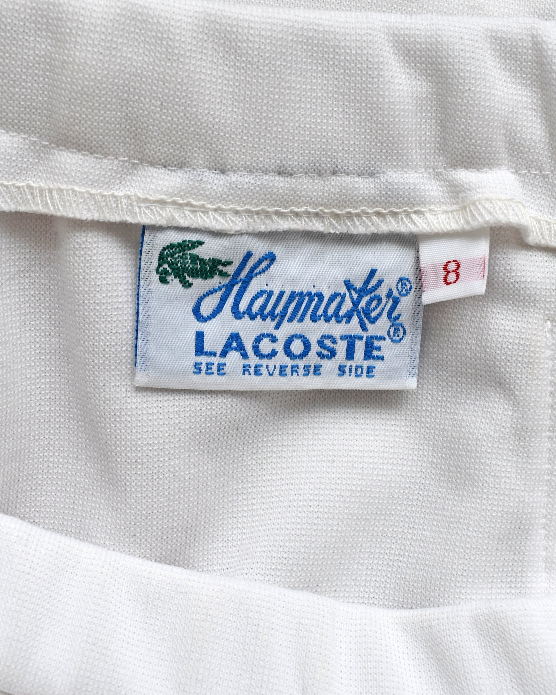 Close-up of a Haymaker Lacoste label with a crocodile logo.