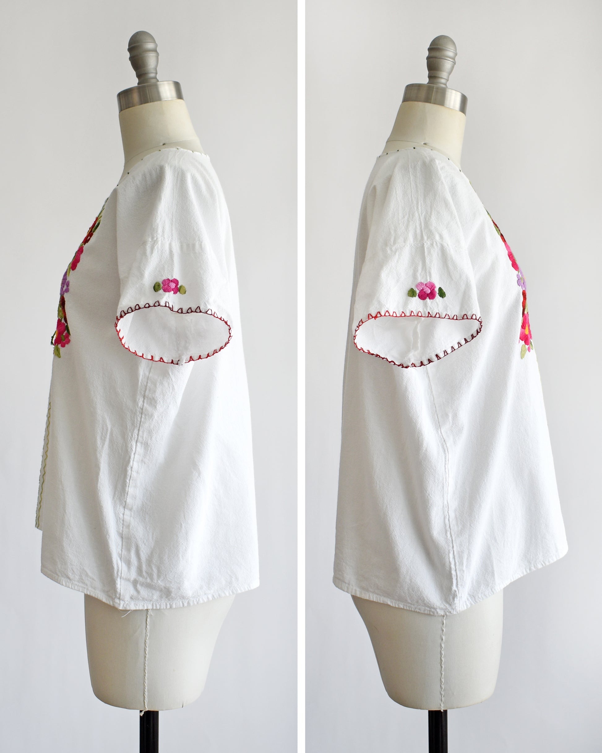 side by side view of the sides of a vintage 1970s white blouse with colorful floral embroidery on a mannequin against a white background