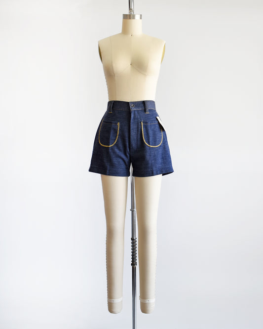  vintage 1970s navy faux denim shorts on a dress form