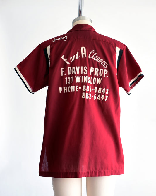 a vintage 1960s Hilton bowling shirt with white text on a mannequin against a white background