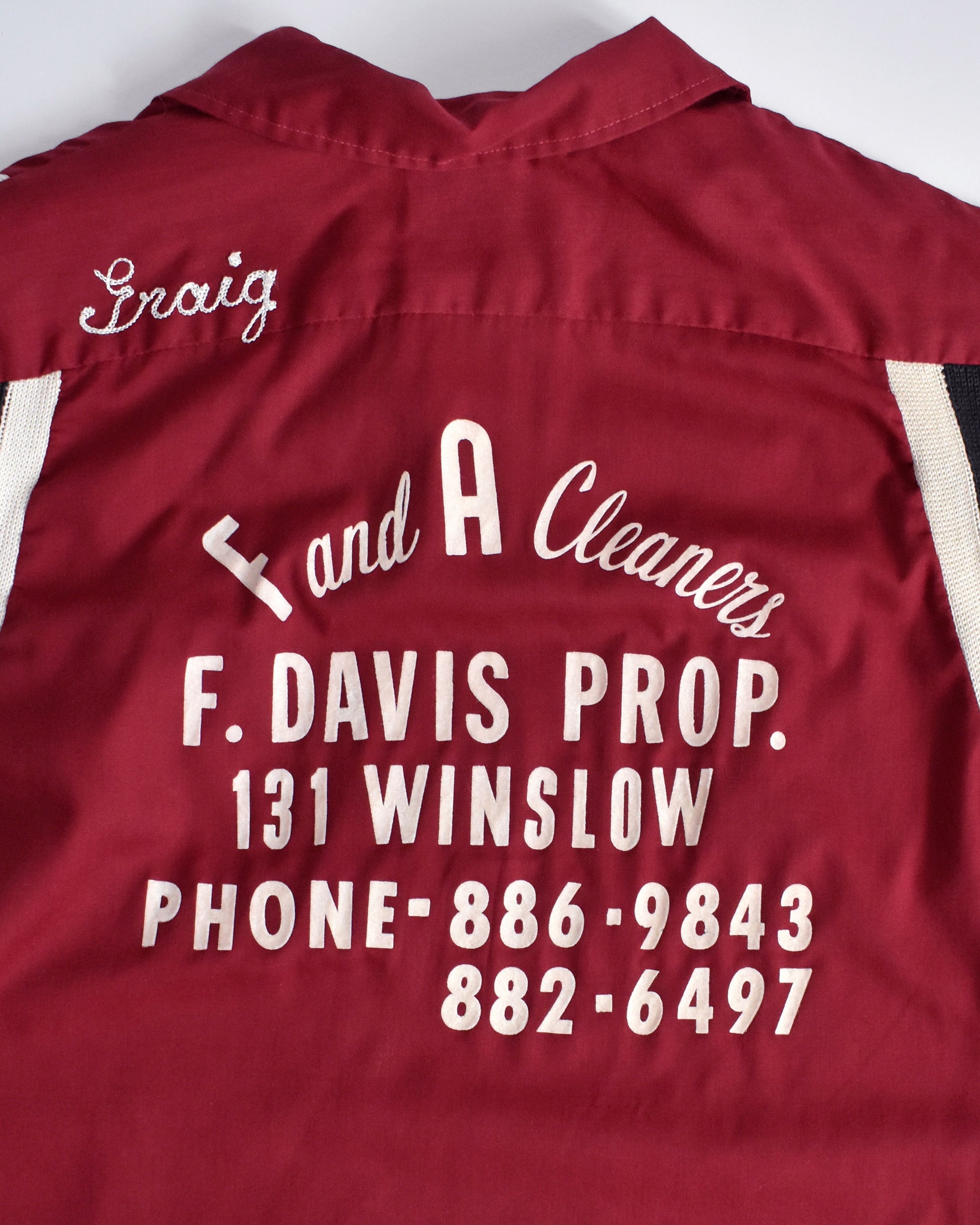 overlay view of the back of a vintage 1950s Hilton bowling shirt with white text on a mannequin against a white background