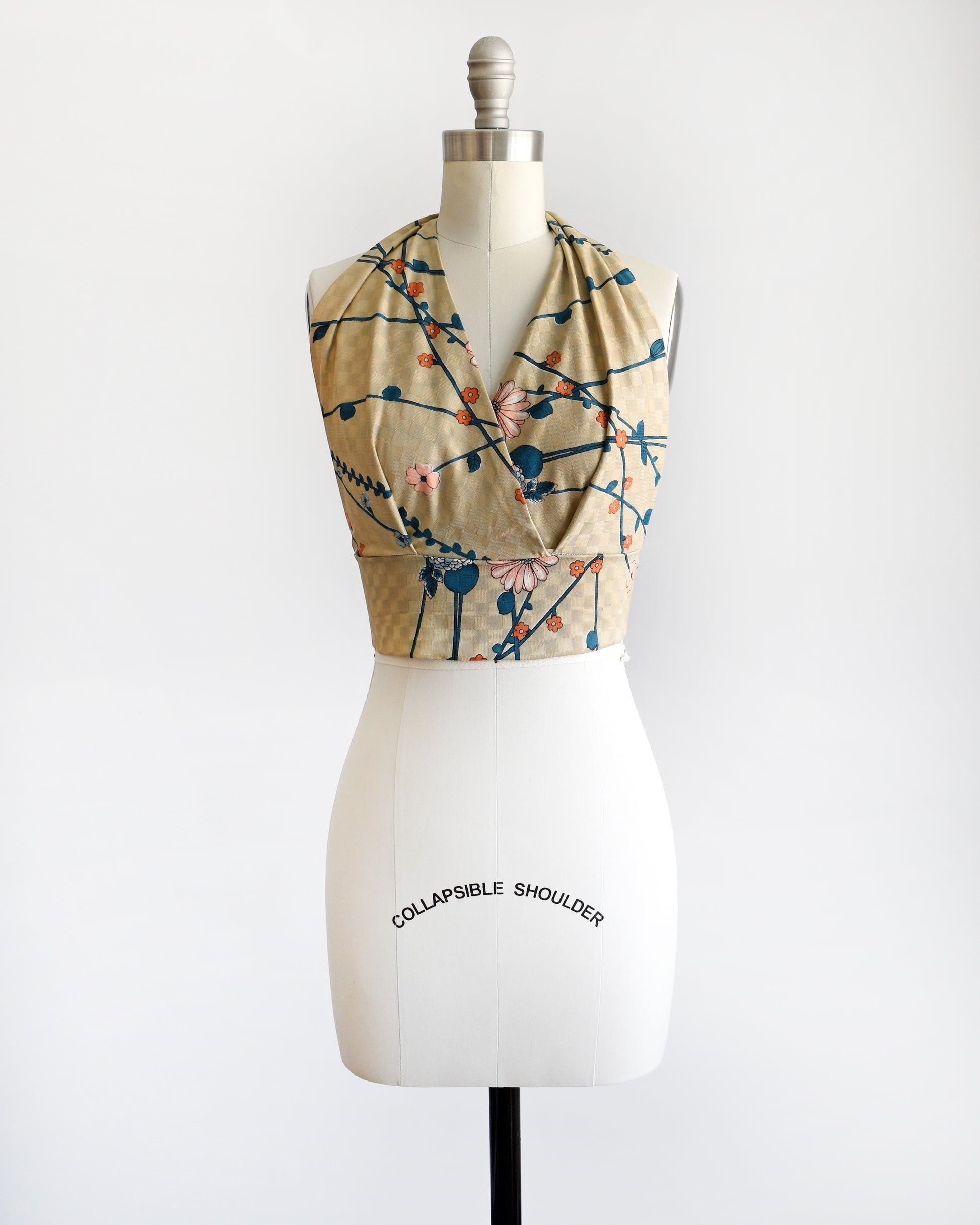 a vintage 1970s floral halter top on a dress form