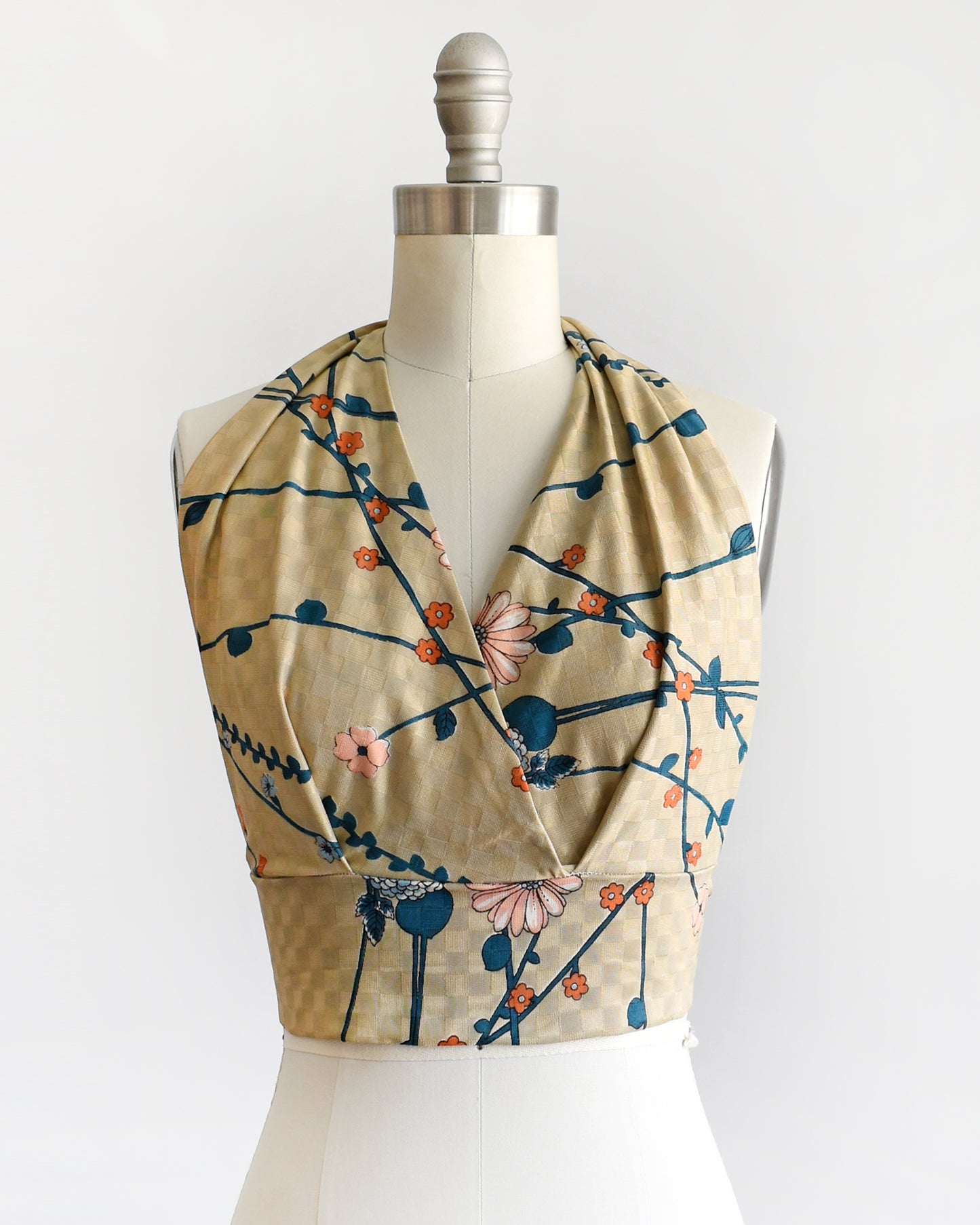 a vintage 1970s floral halter top on a dress form