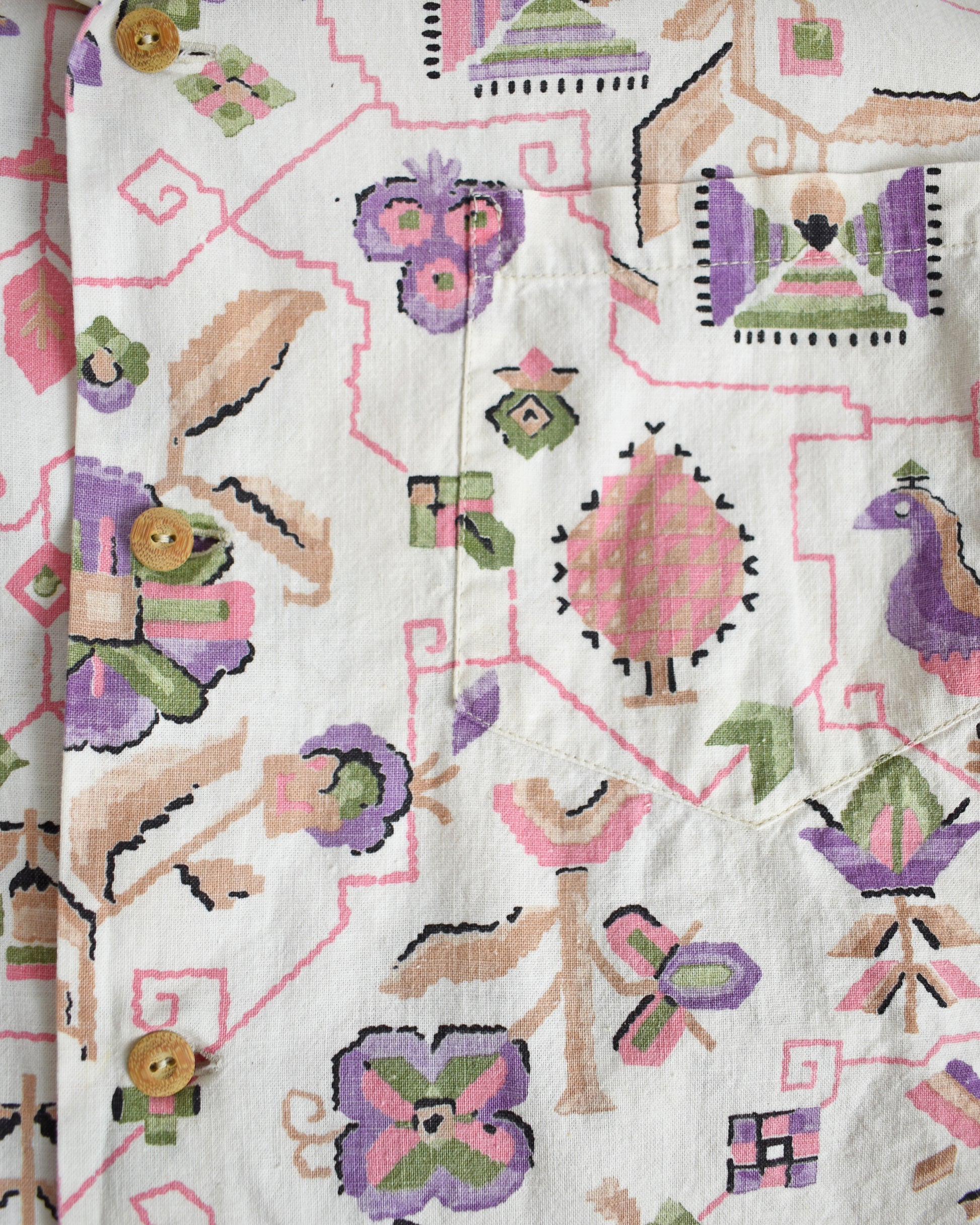 close up of the colorful pattern on a vintage 1950s Tiana Pittelle short-sleeve Hawaiian aloha shirt