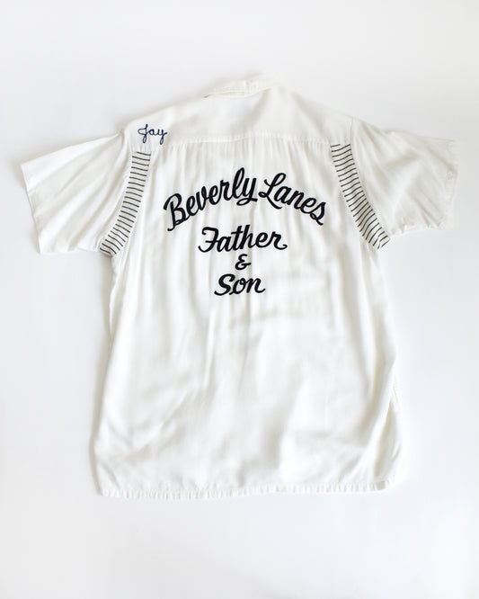 a vintage 1950s Olympian bowling white shirt with 'Beverly Lanes Father & Son' text on a white background
