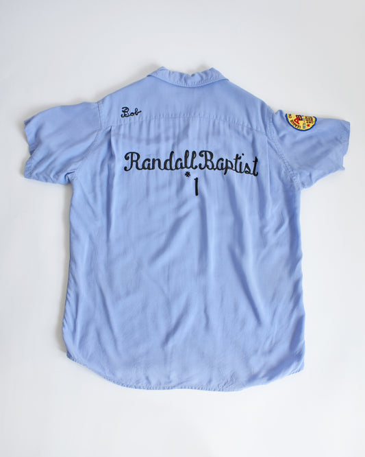 a vintage 1950s*1960s Hilton bowling shirt in light blue shirt with 'Randall Baptist' chain stitch text on a white background