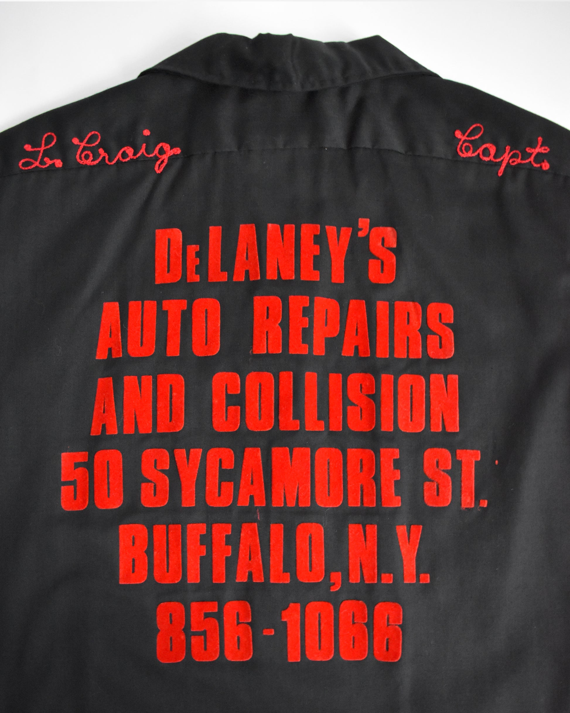 close up of the red lettering on the back of the bowling shirt