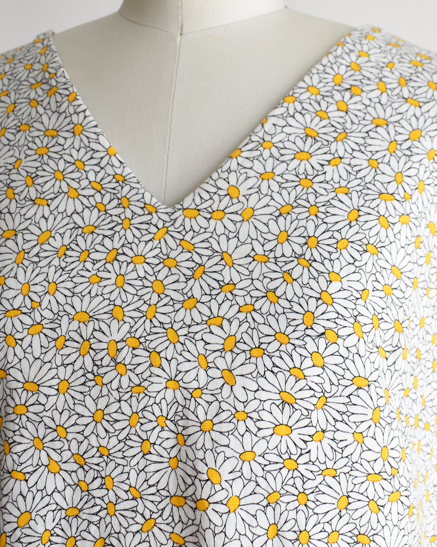 close up of the vintage floral sleeveless top on a mannequin