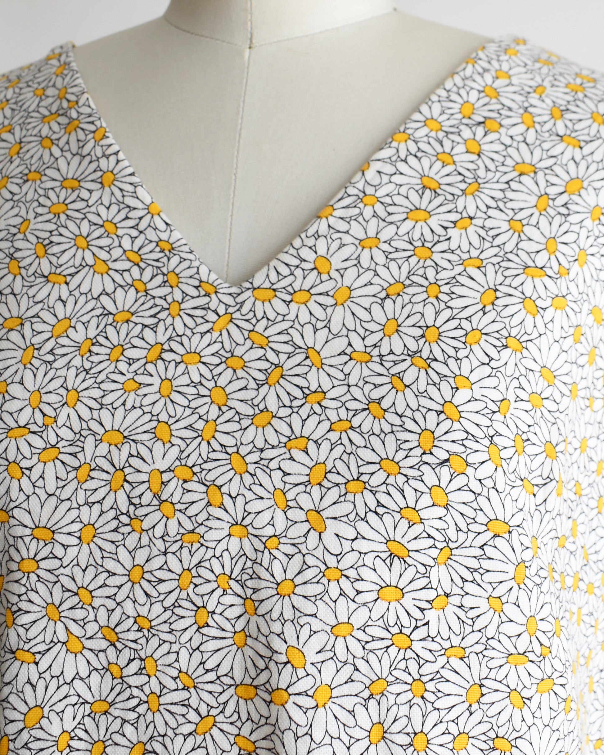 close up of the vintage floral sleeveless top on a mannequin