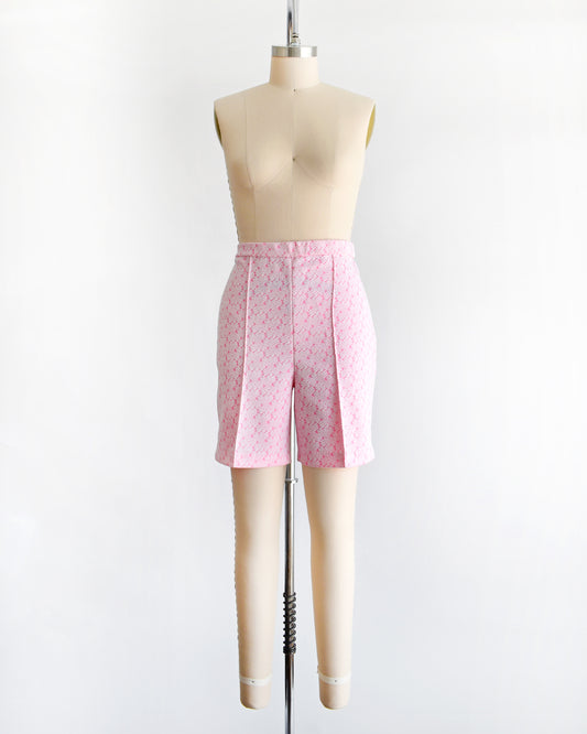 vintage 70s pink and white shorts on a mannequin against a white background