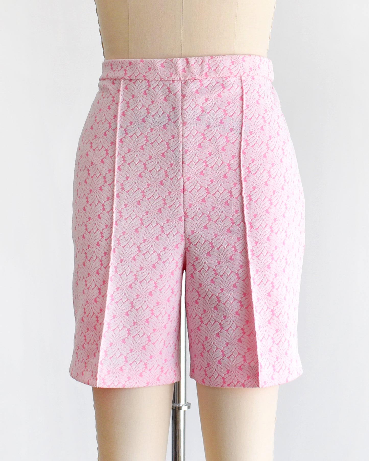 vintage 70s pink and white shorts on a mannequin against a white background