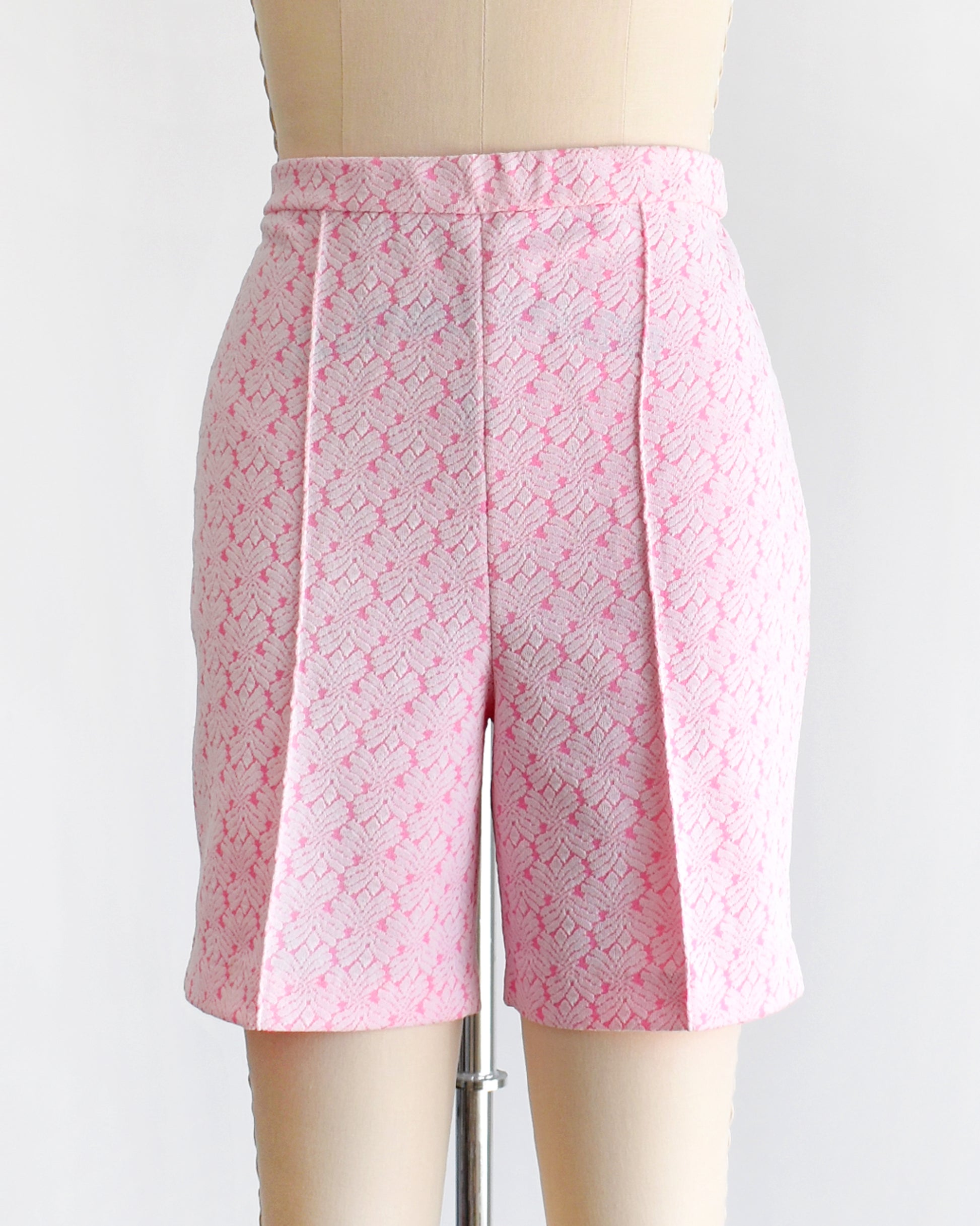 vintage 70s pink and white shorts on a mannequin against a white background