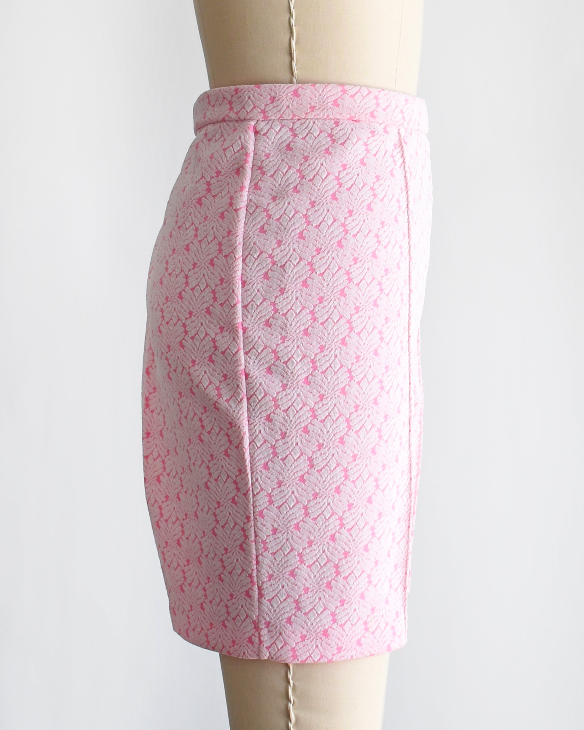 side view of vintage 70s pink and white shorts on a mannequin against a white background