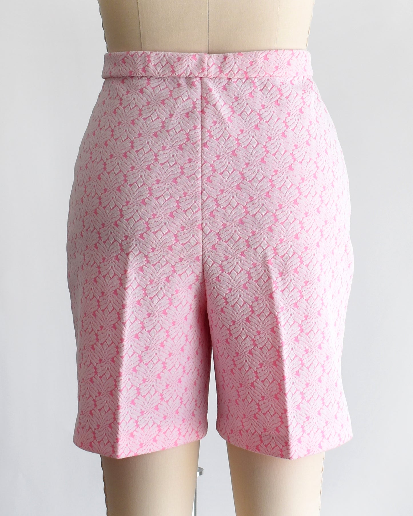 back view of vintage 70s pink and white shorts on a mannequin against a white background