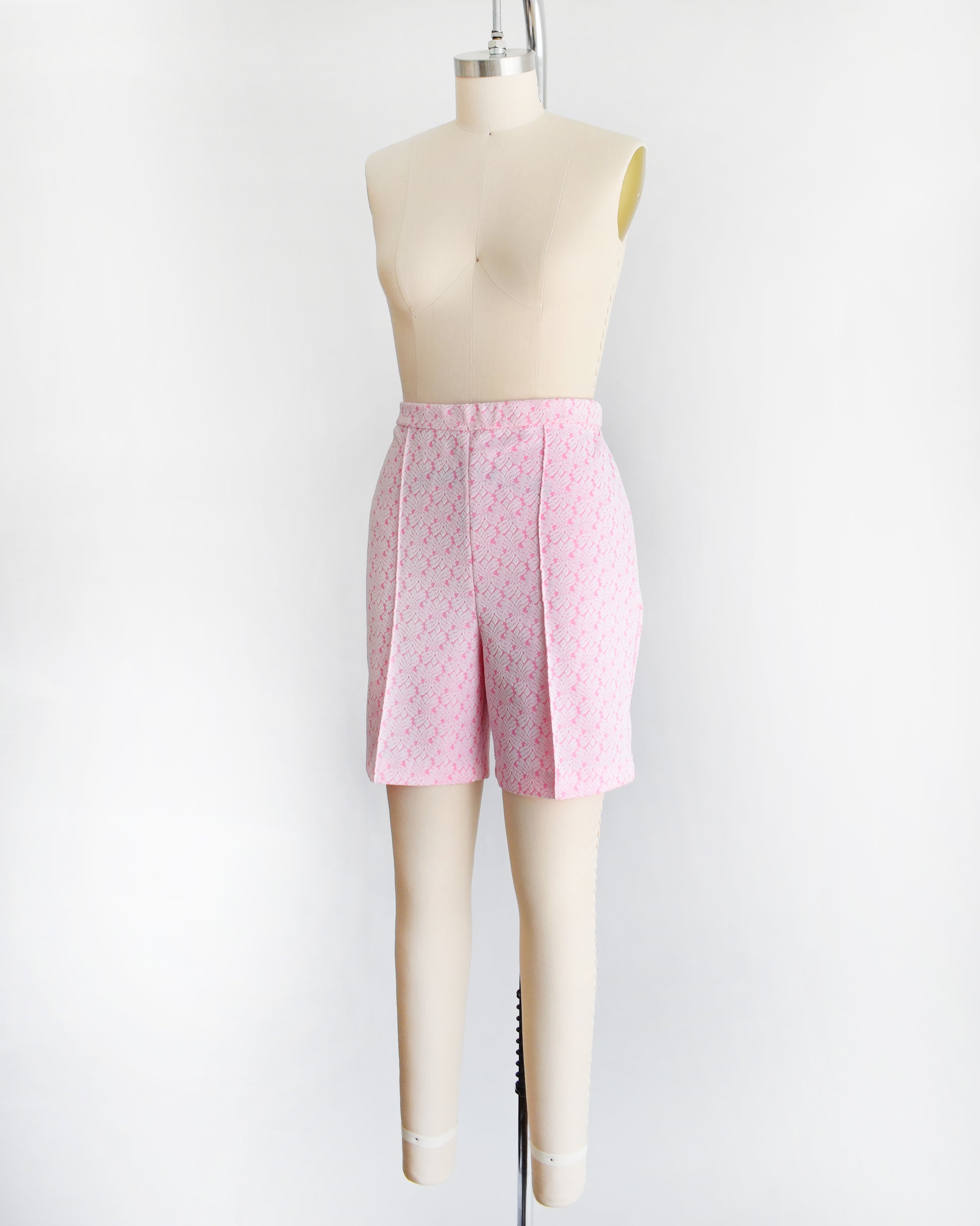 side front view of vintage 70s pink and white shorts on a mannequin against a white background