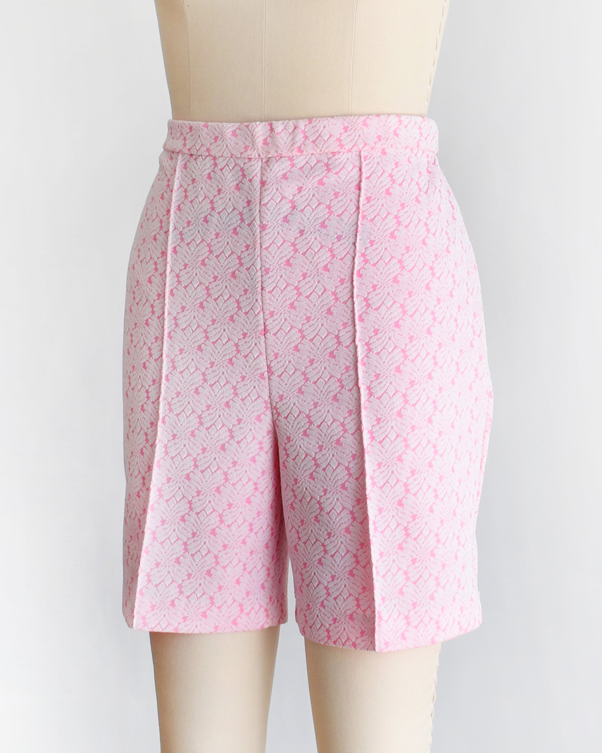 side front view of vintage 70s pink and white shorts on a mannequin against a white background