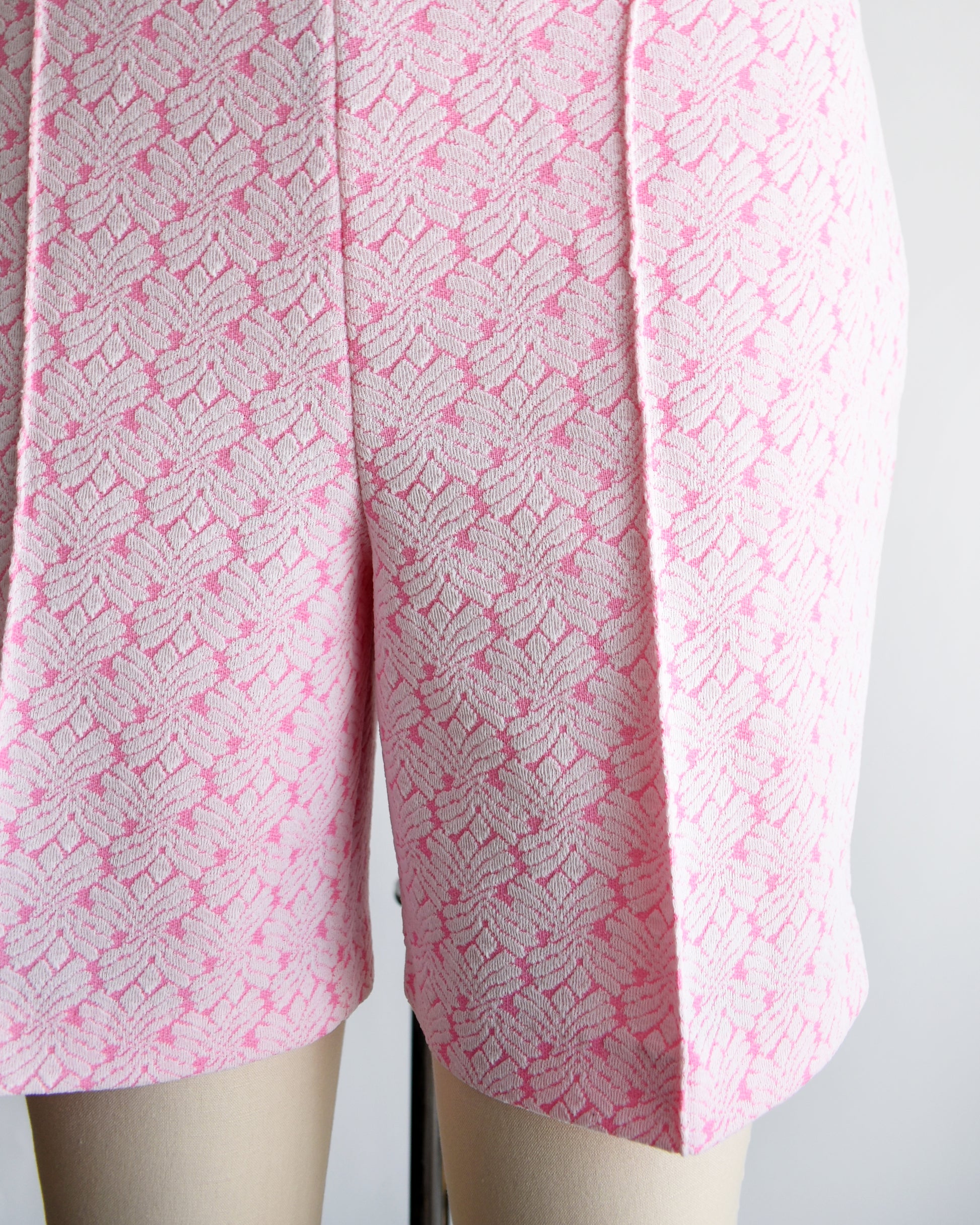 close up of vintage 70s pink and white shorts on a mannequin against a white background