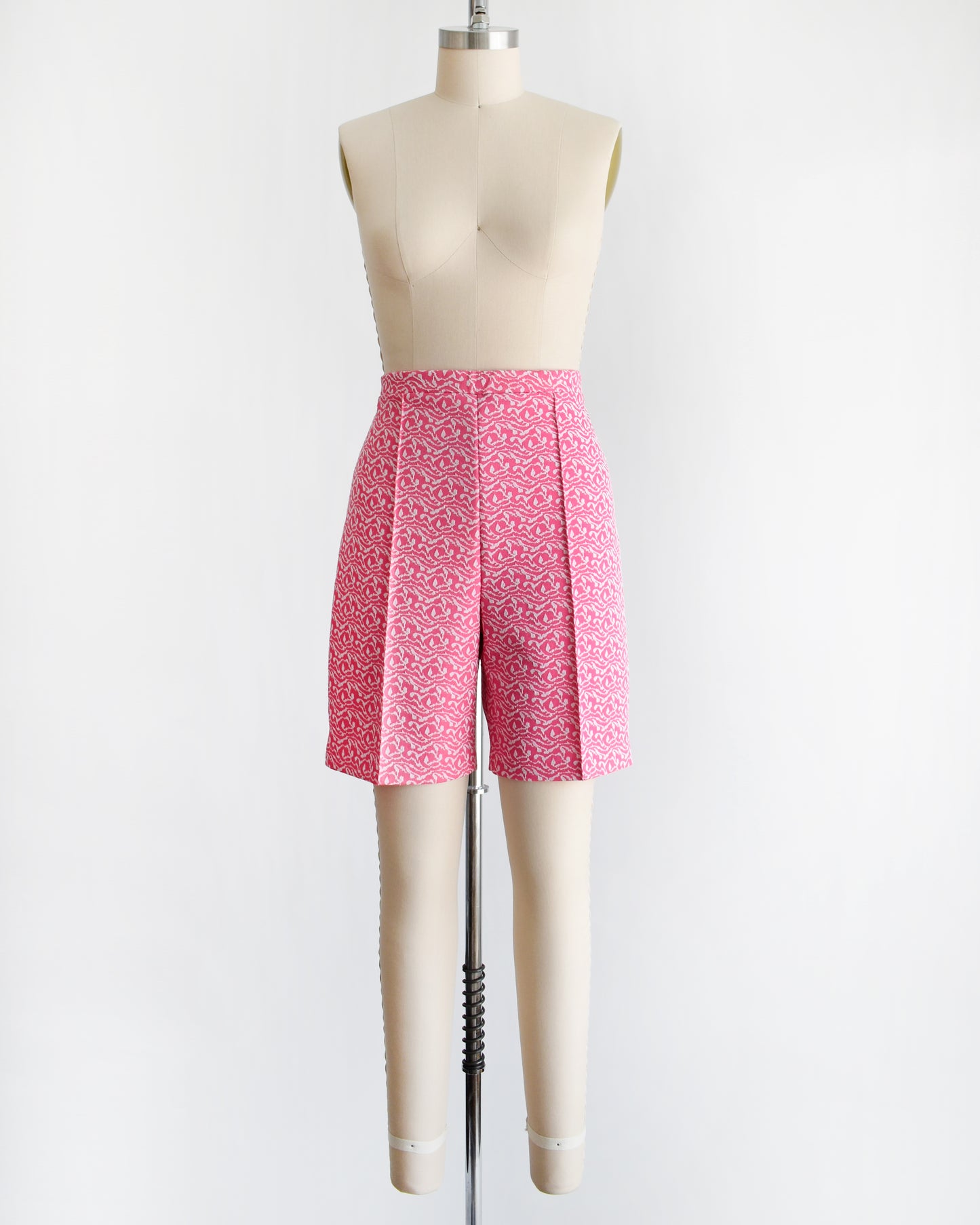 vintage 70s pink and white shorts on a mannequin against a white background