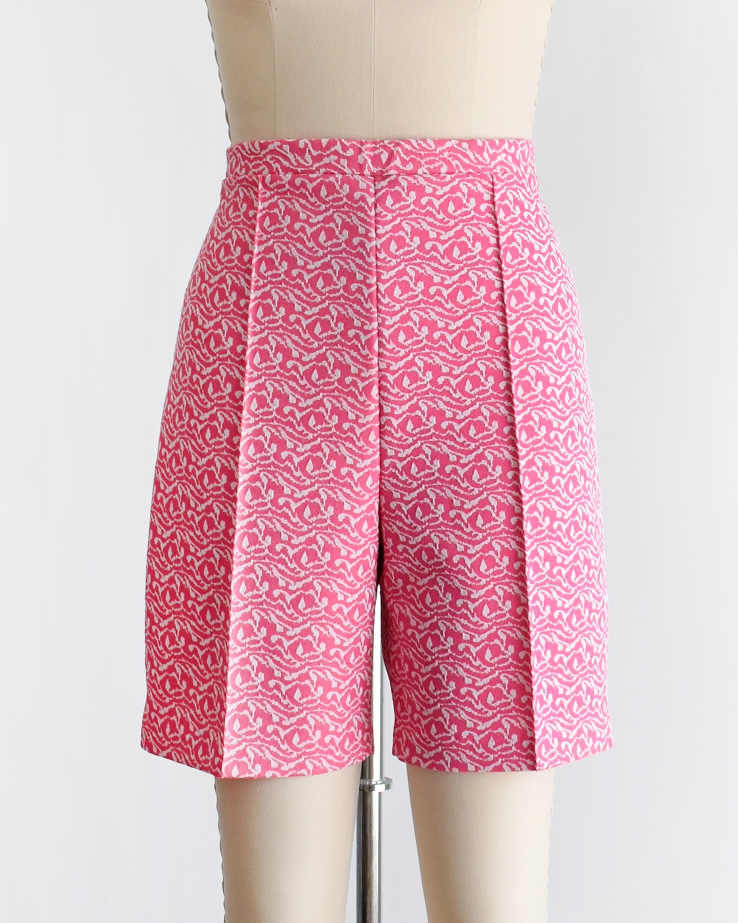 vintage 70s pink and white shorts on a mannequin against a white background