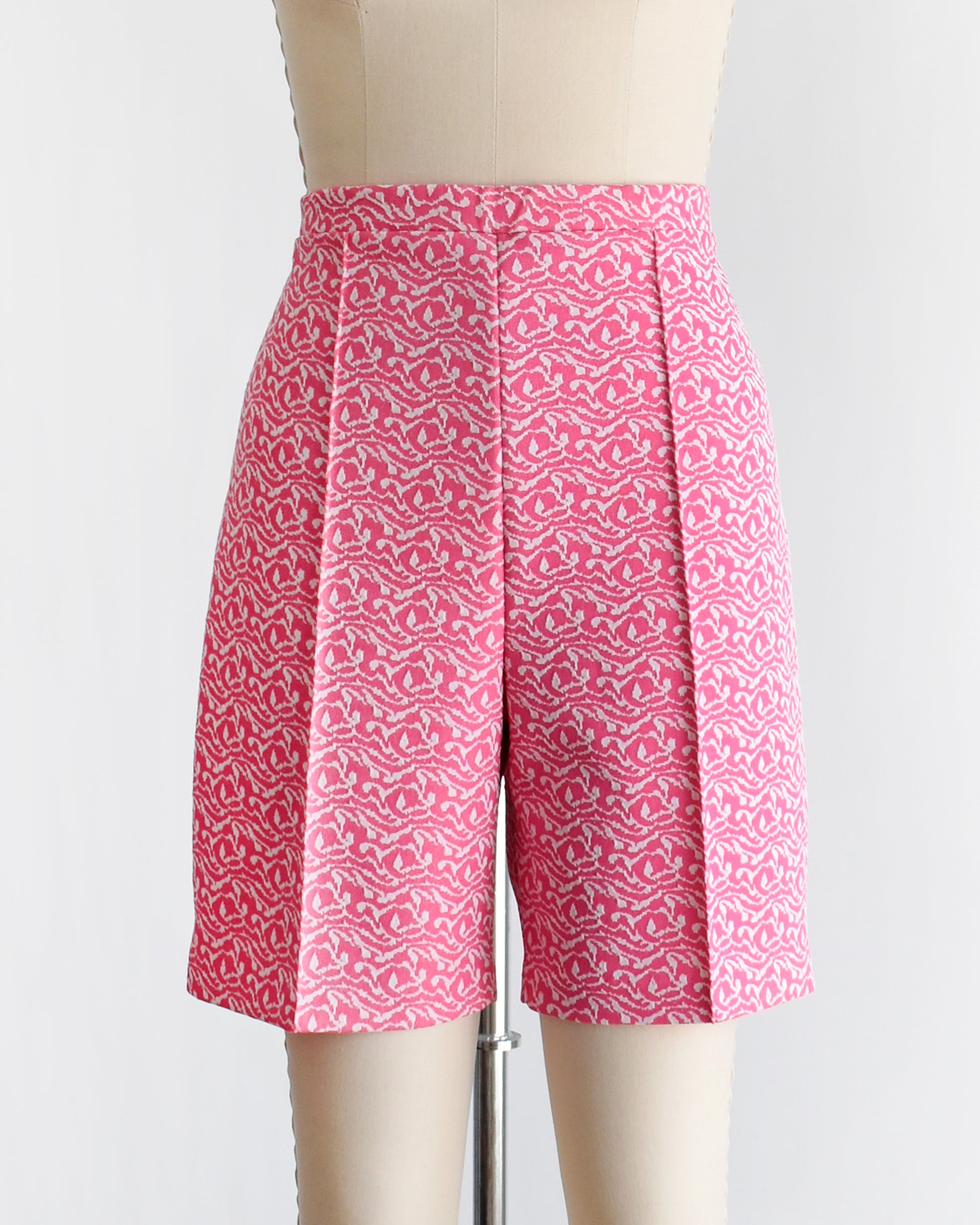 vintage 70s pink and white shorts on a mannequin against a white background