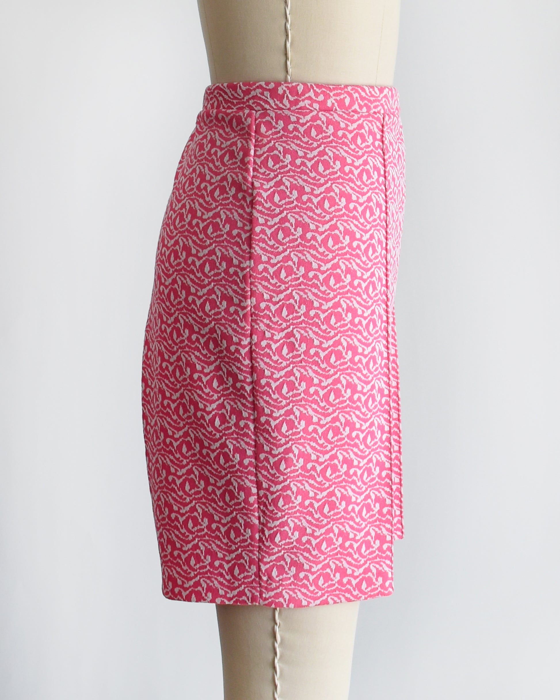 side view of vintage 70s pink and white shorts on a mannequin against a white background