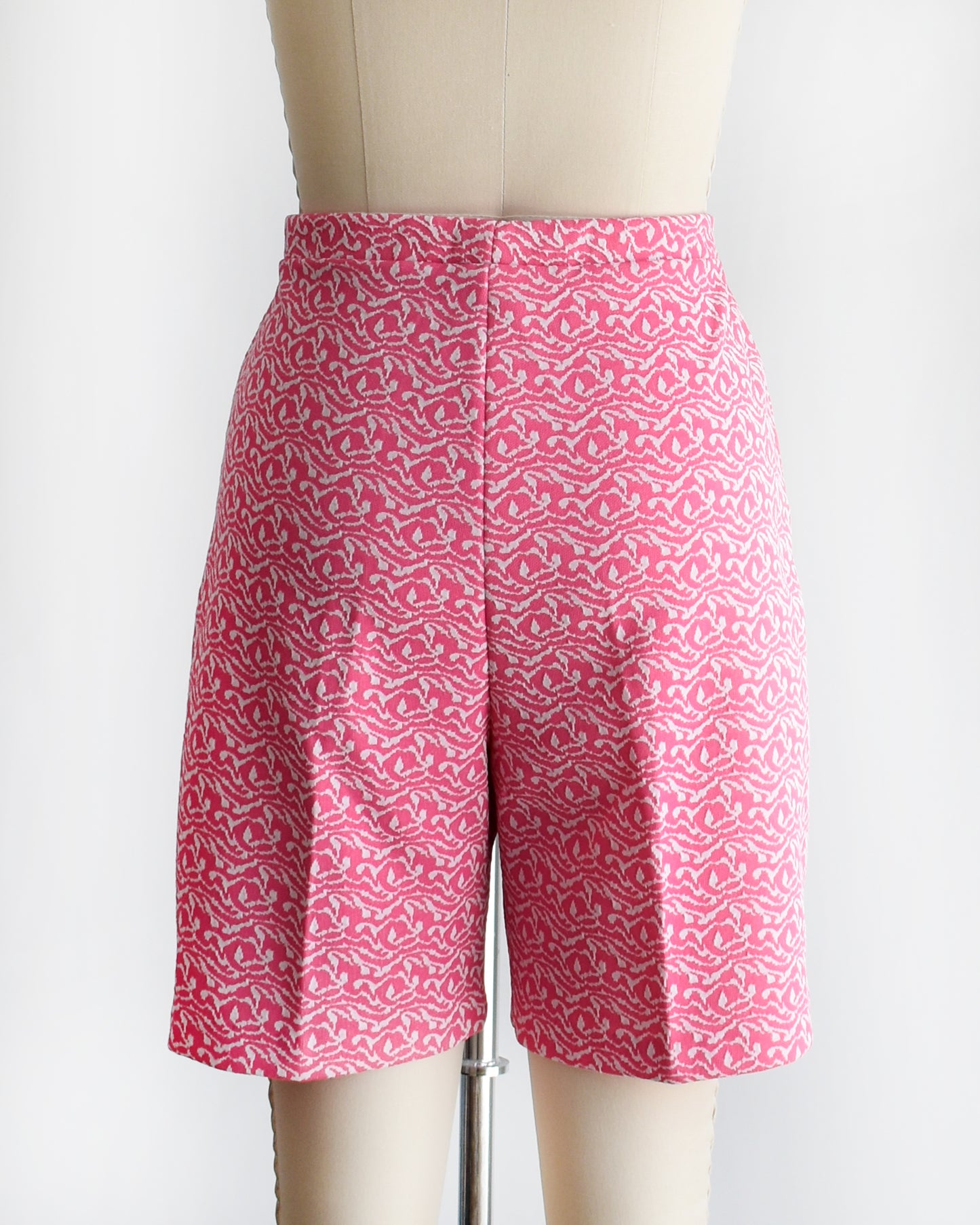 back view of vintage 70s pink and white shorts on a mannequin against a white background