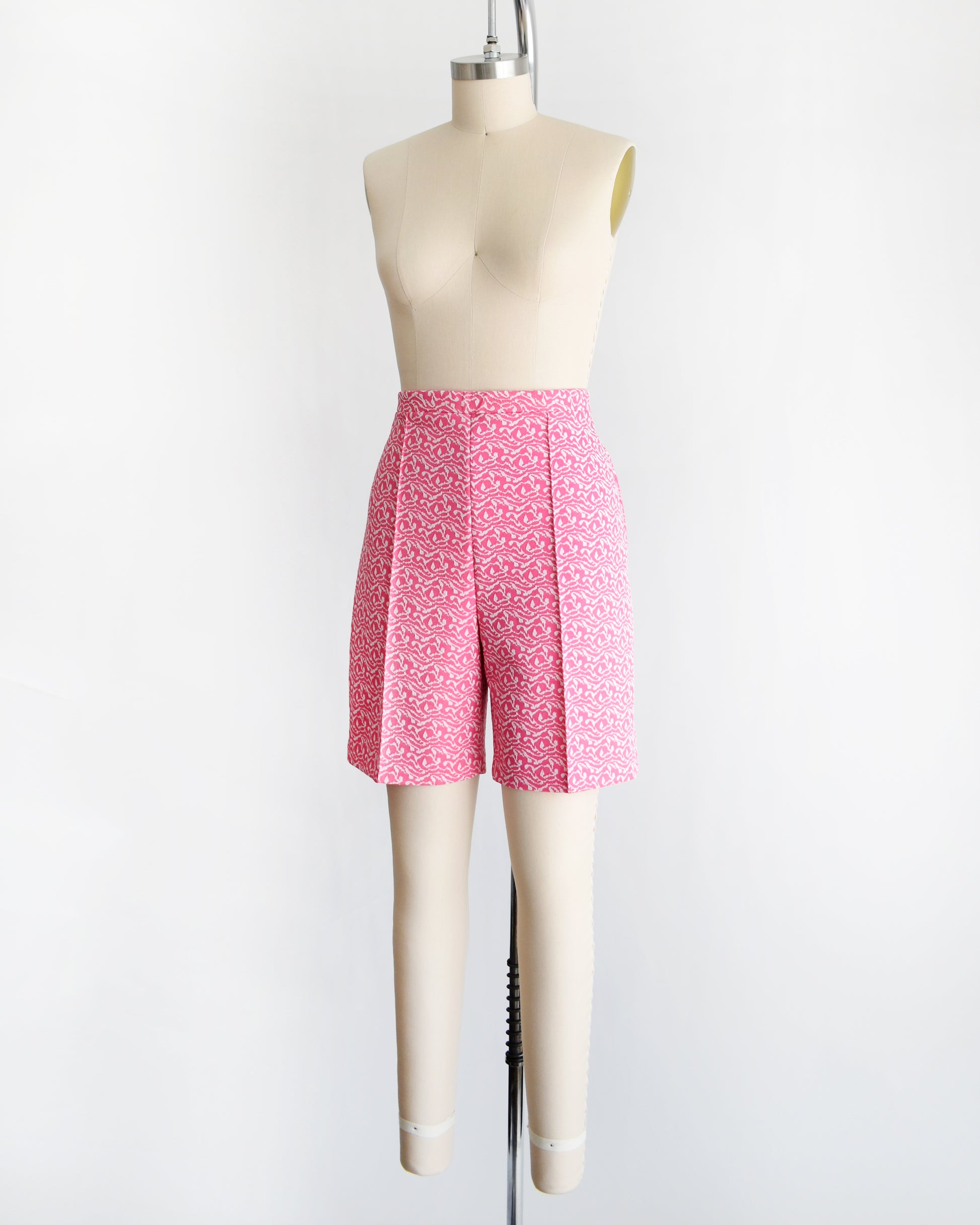 side front view of vintage 70s pink and white shorts on a mannequin against a white background