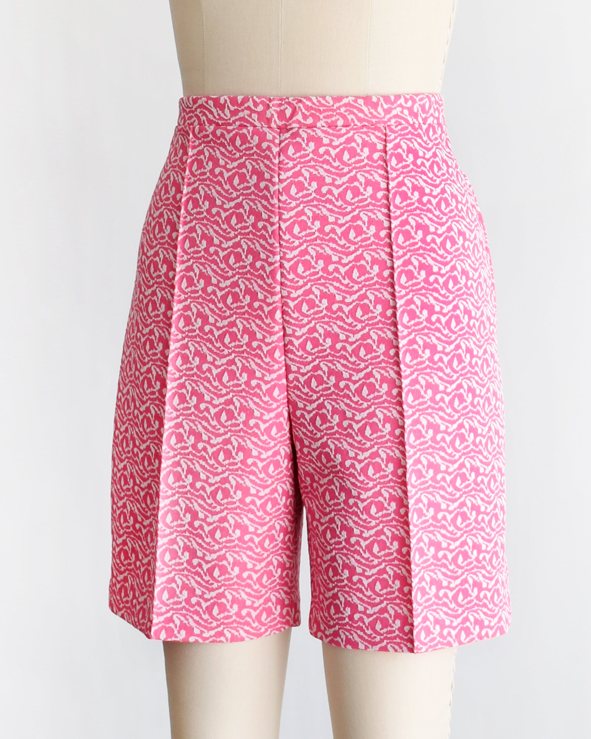 side front view of vintage 70s pink and white shorts on a mannequin against a white background