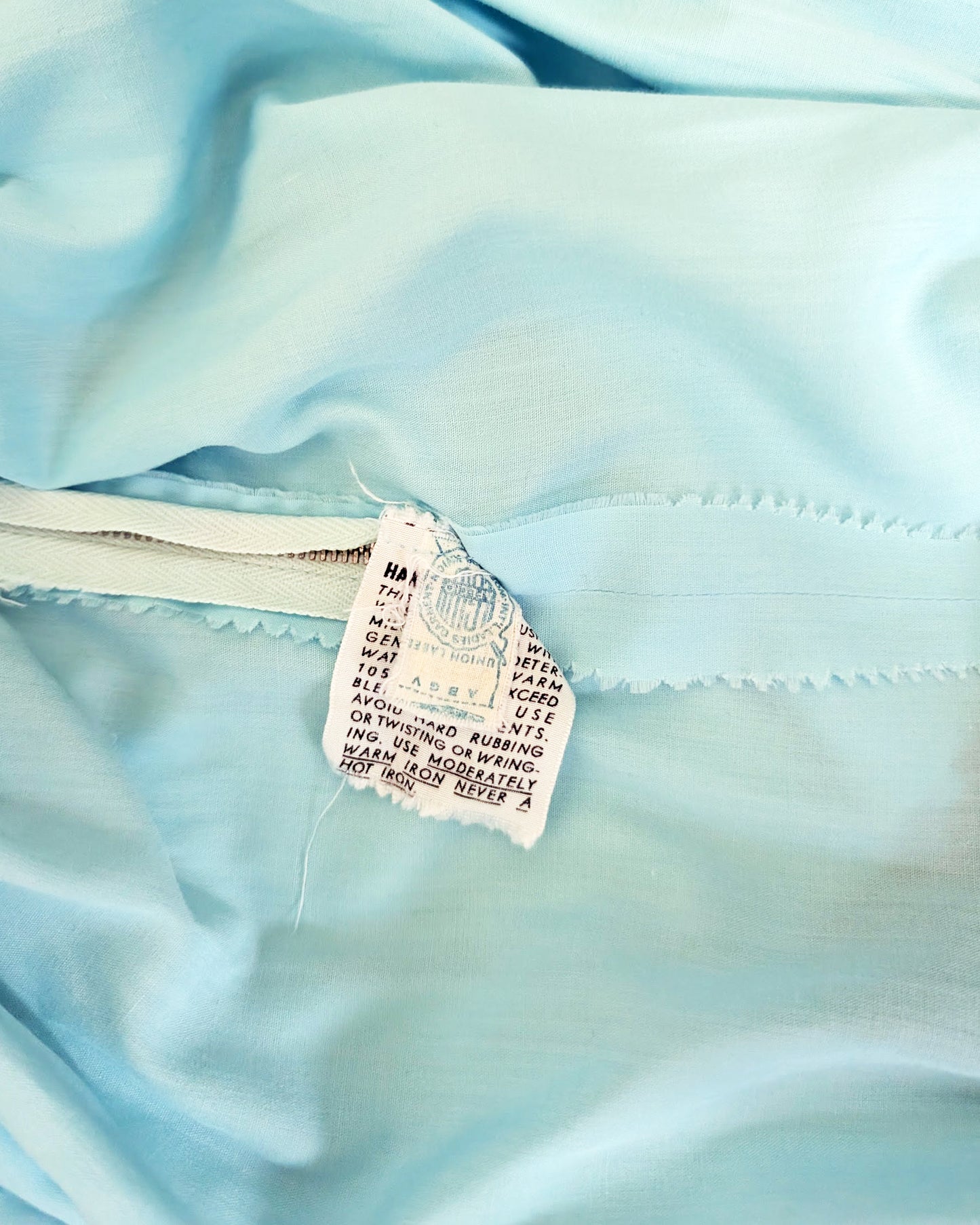 close up of the vintage ILGWU tag and care tag